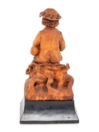 A Continental Carved Wood Statue of a Bagpipe Player