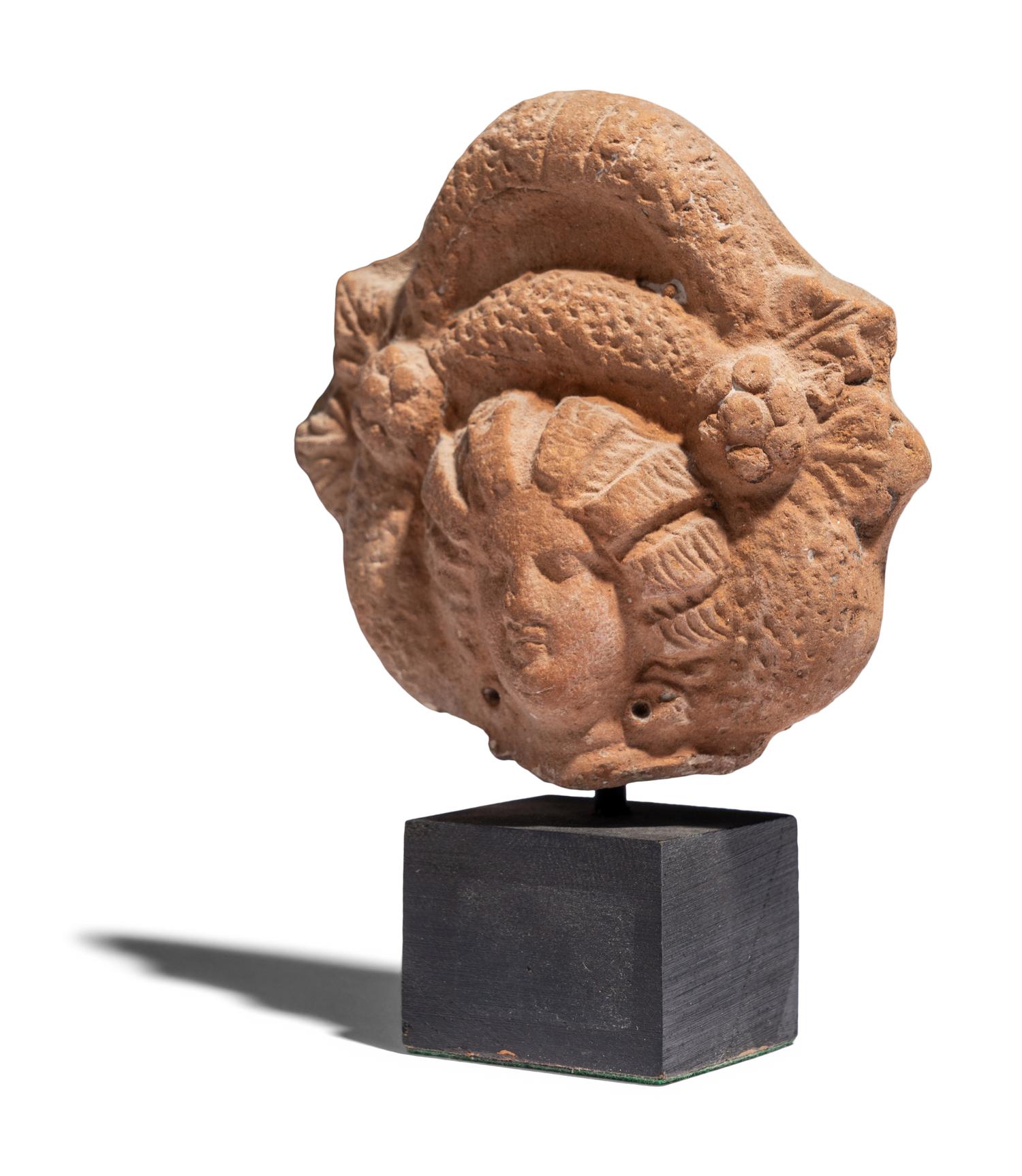 An Egyptian Terracotta Head of a Goddess
