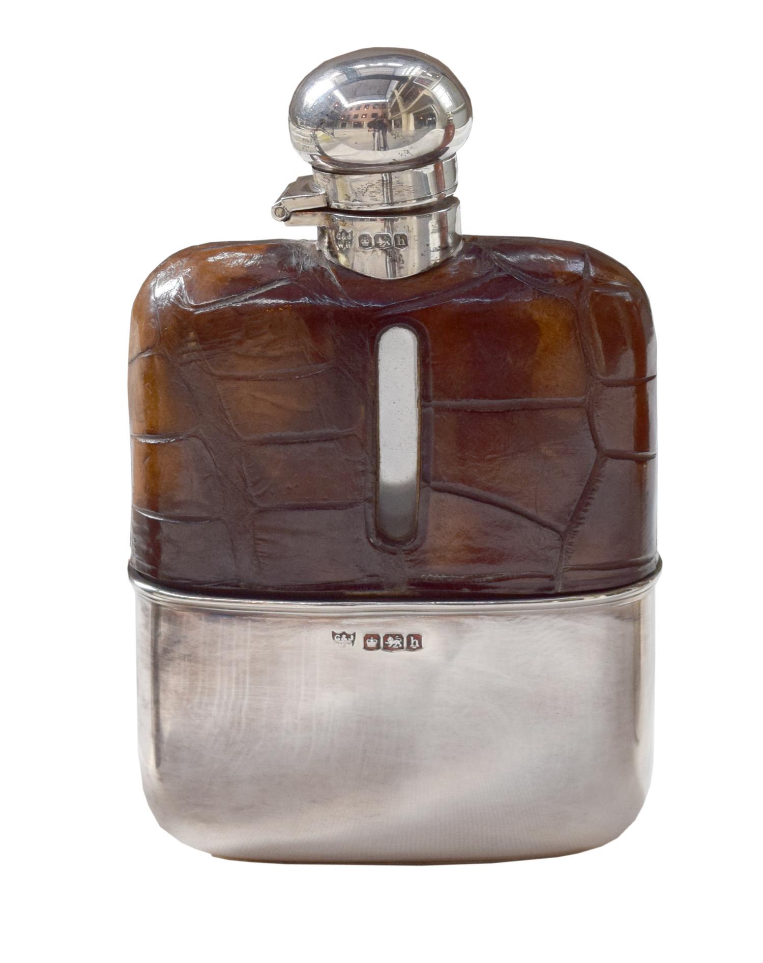 A Set of Three Silver and Stamped Leather Hip Flasks Left: 2.25" x .5" x 3.75" tall: Middle: 3" x 1" x 5" tall: Right: 3.25" x 1" x 5.5 — England, Circa 1925-1940