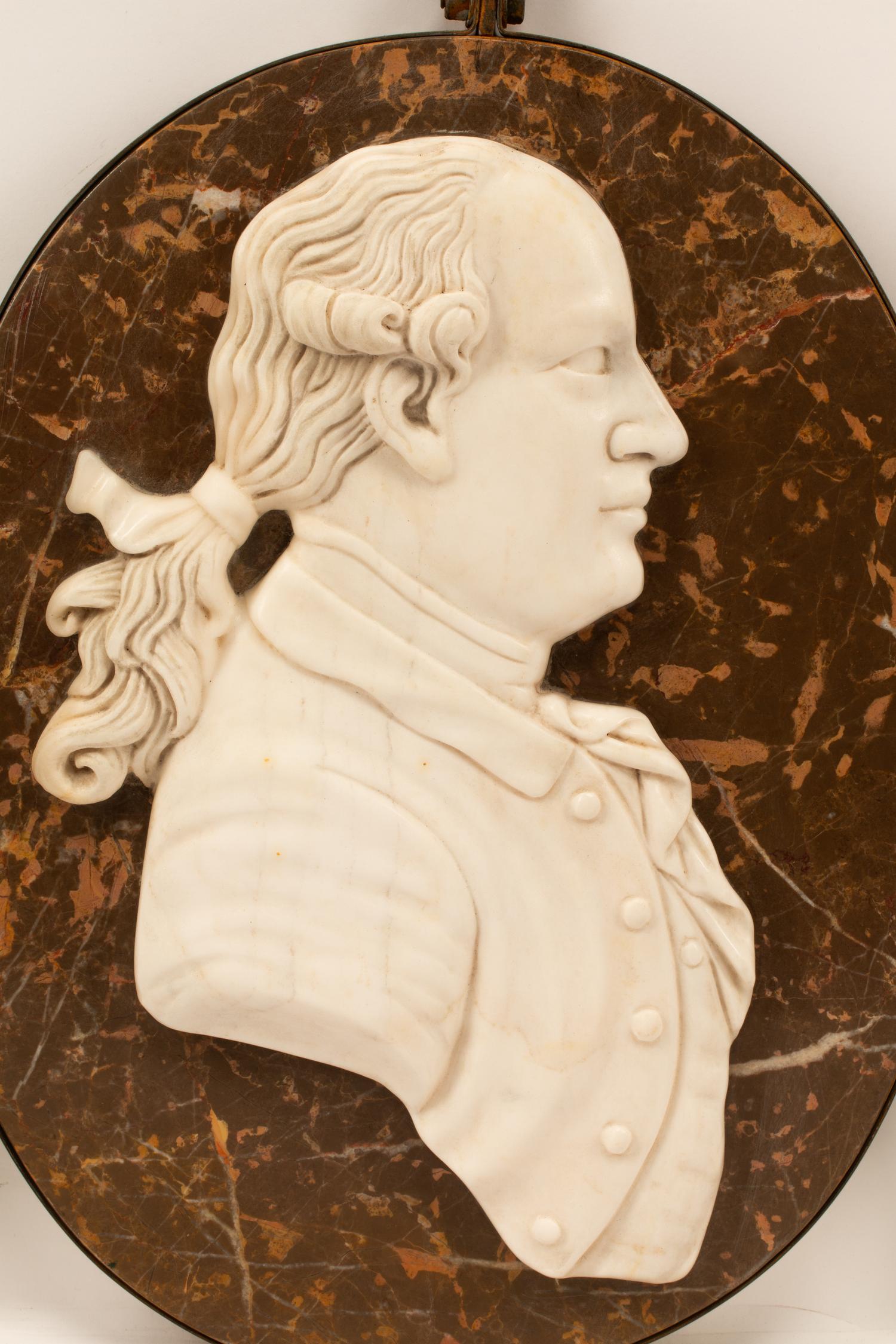 A Set of Four Iron-Framed Marble Portrait Medallions