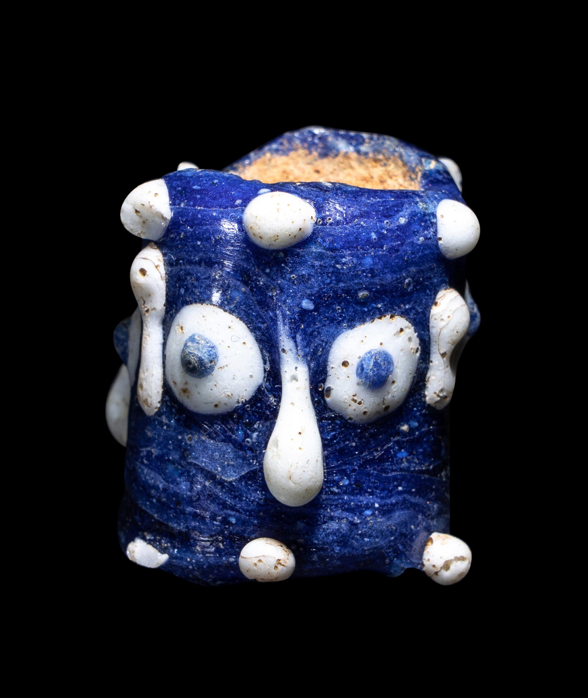 A Phoenician Glass Triple-Face Bead