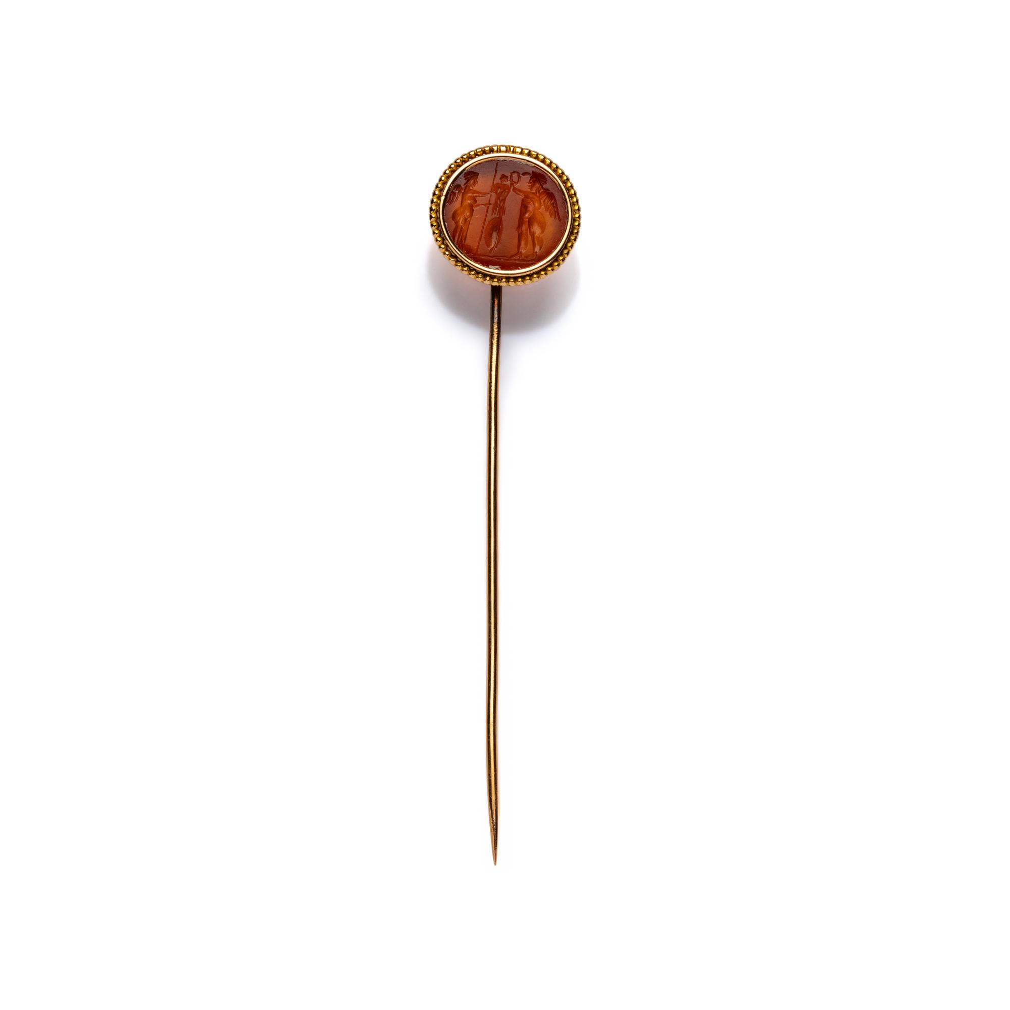 A Roman Carnelian Intaglio with Two Erotes Flanking a Tropaion — Set in a 19th century gold pin