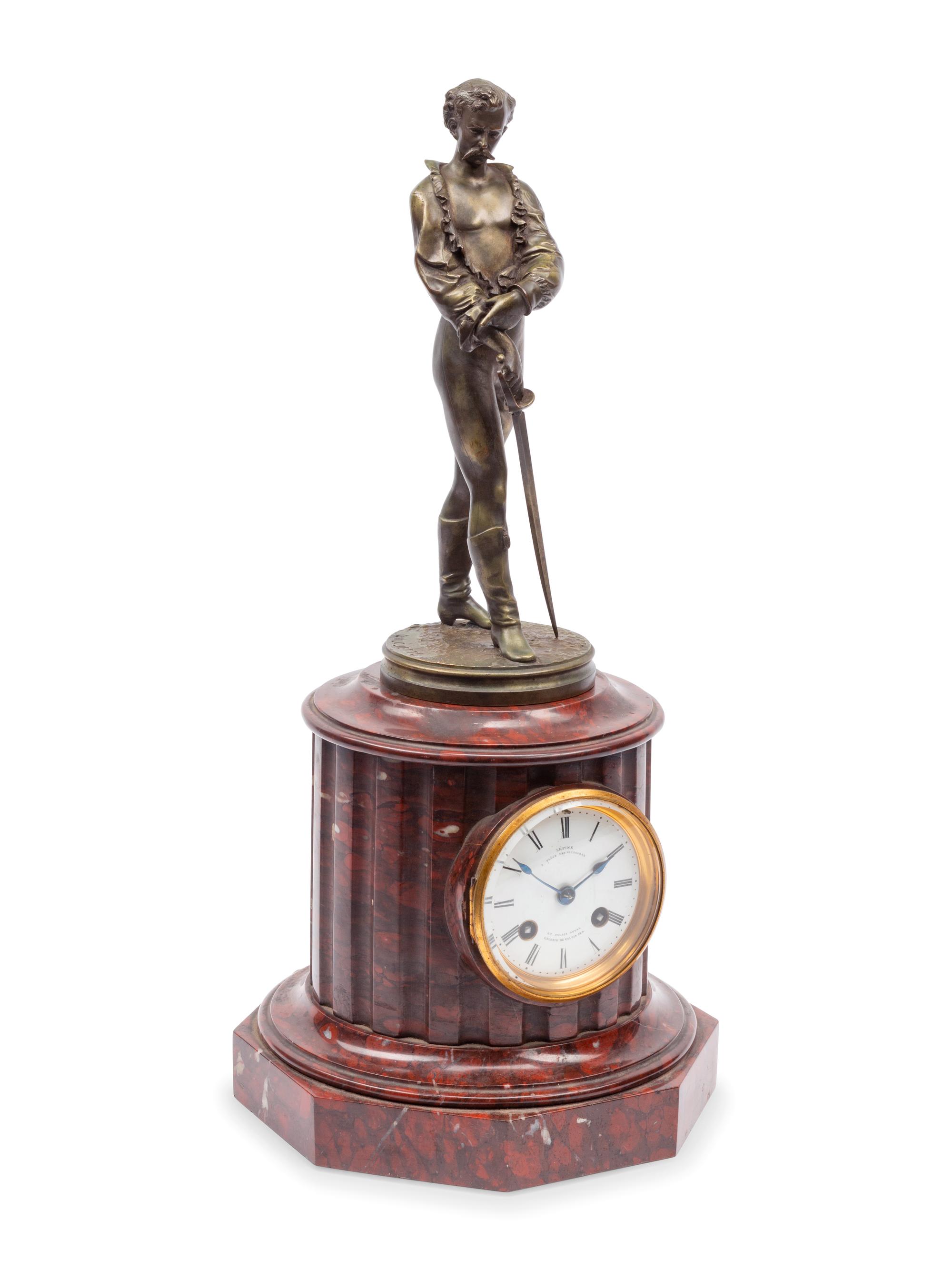A French Patinated Bronze and Rouge Marble Figural Mantel Clock
