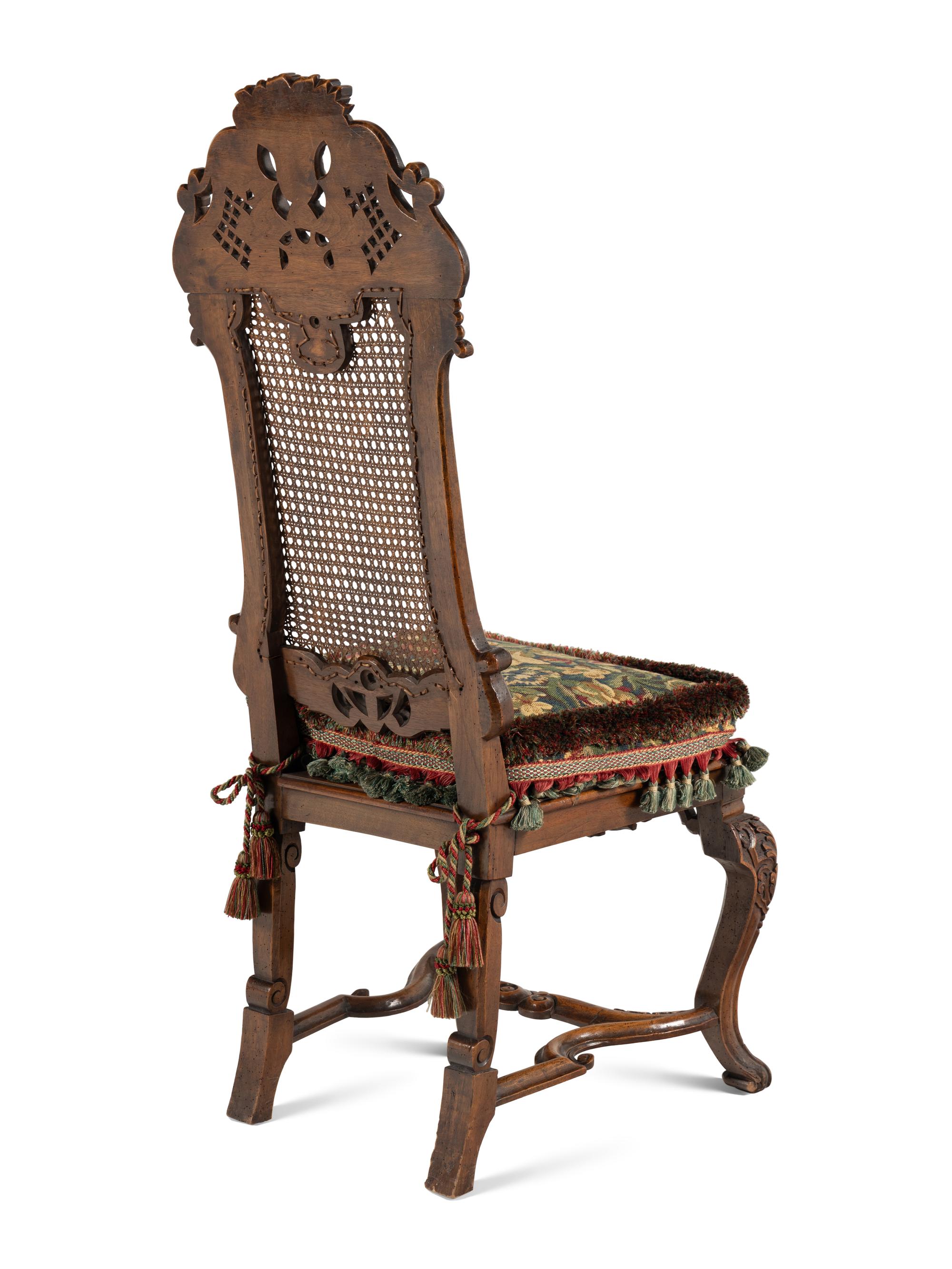 A Set of Four William and Mary Style Caned and Pierced-Carved Walnut Dining Chairs