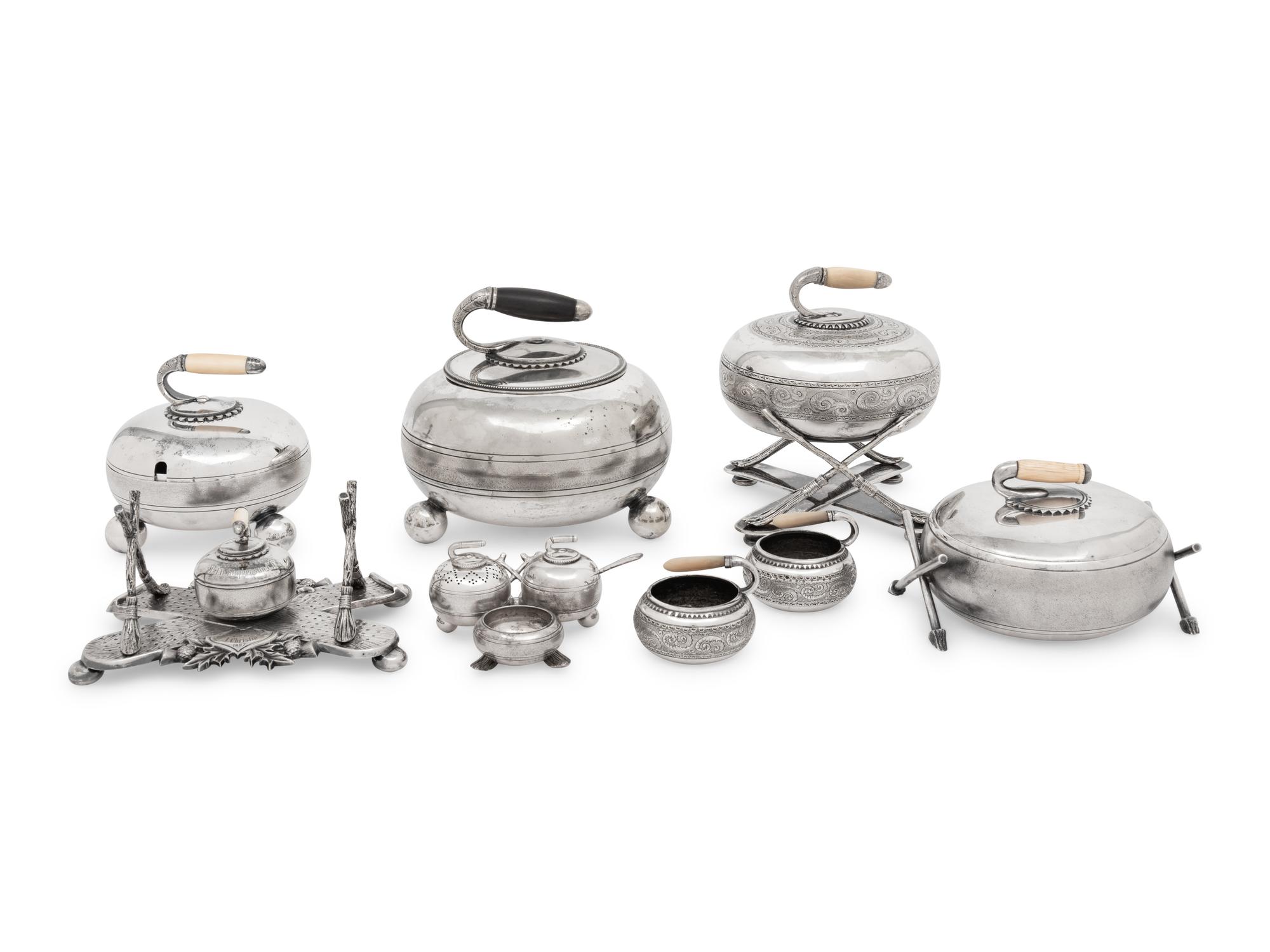 A Group of Eight Curling Stone-Form Silver-Plate Table Articles