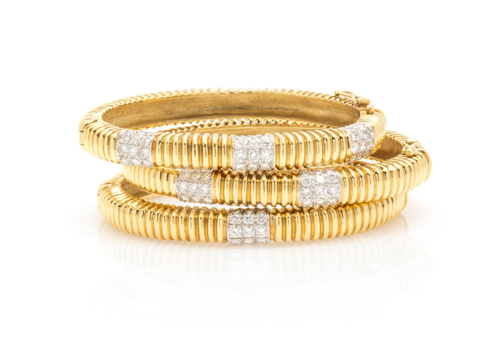 A Collection of 18 Karat Gold and Diamond Bangle Bracelets, 71.20 dwts.