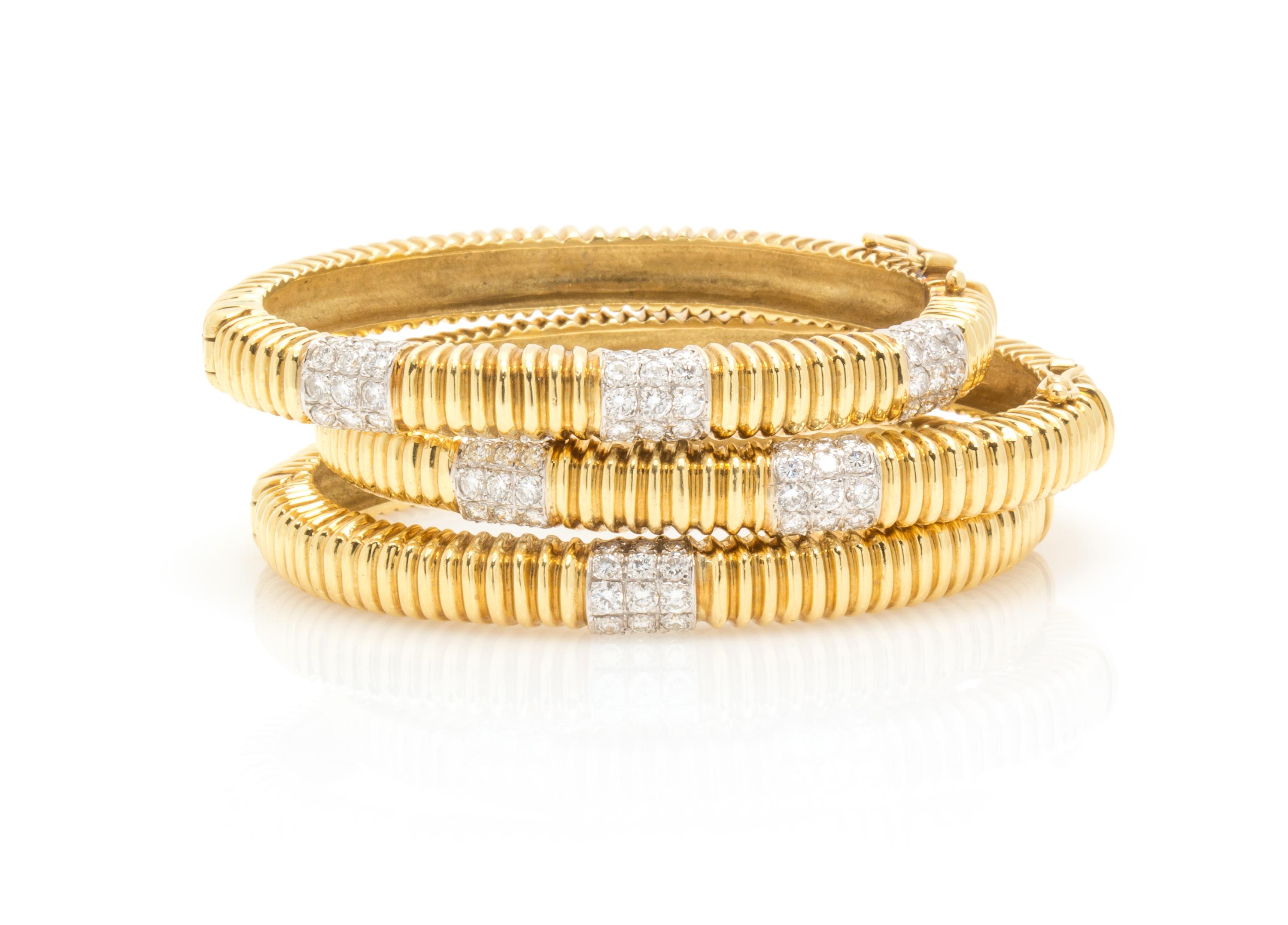 A Collection of 18 Karat Gold and Diamond Bangle Bracelets, 71.20 dwts.