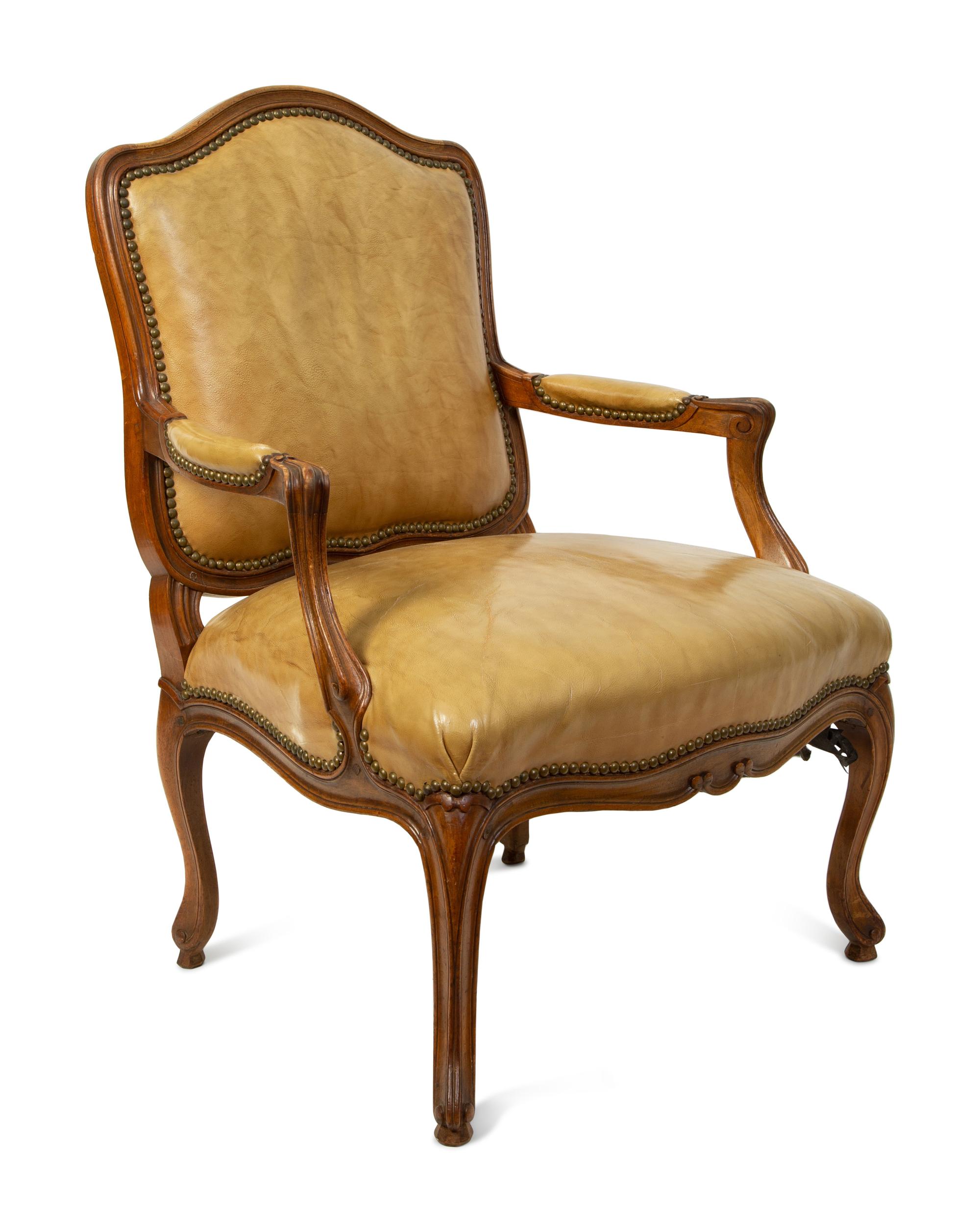 A French Provincial Style Leather Upholstered Fauteuil — 19TH CENTURY