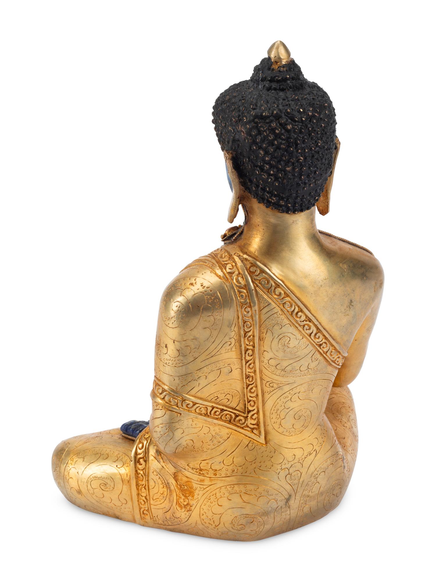 A Tibetan Style Gilt Bronze and Lapis Lazuli Seated Deity