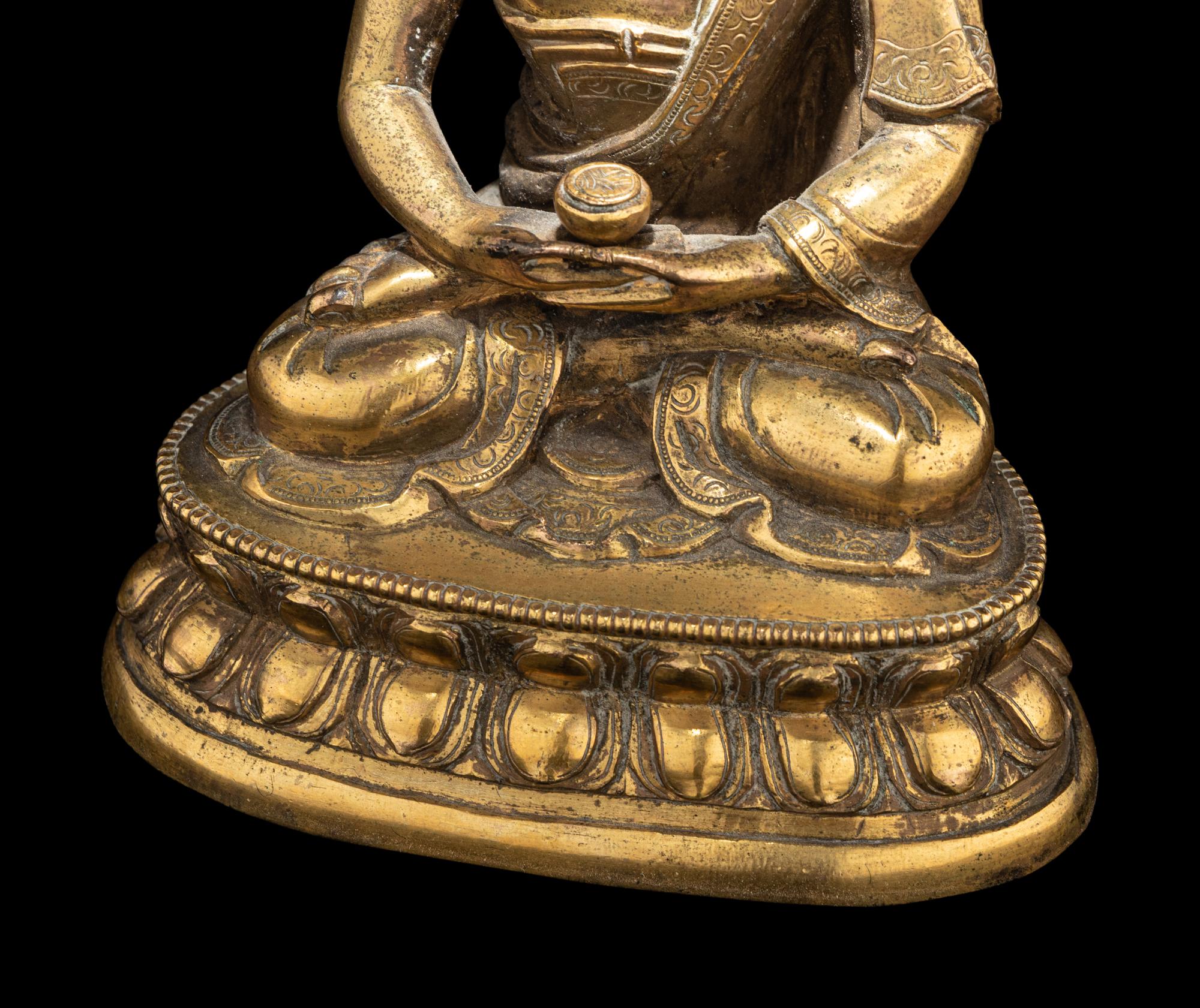 A Small Tibetan Gilt Bronze Figure of Medicine Buddha