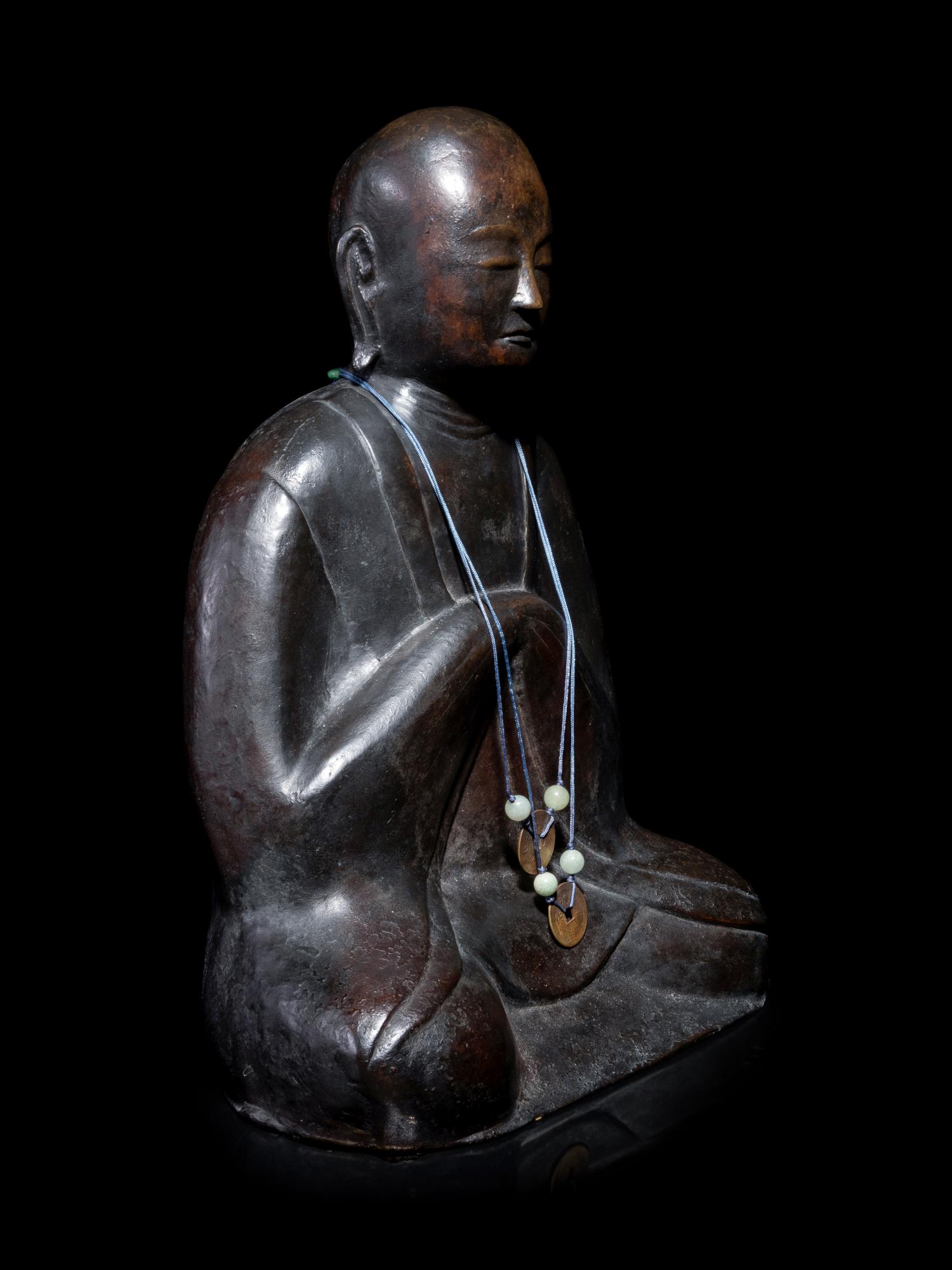 A Chinese Bronze Figure of a Monk
