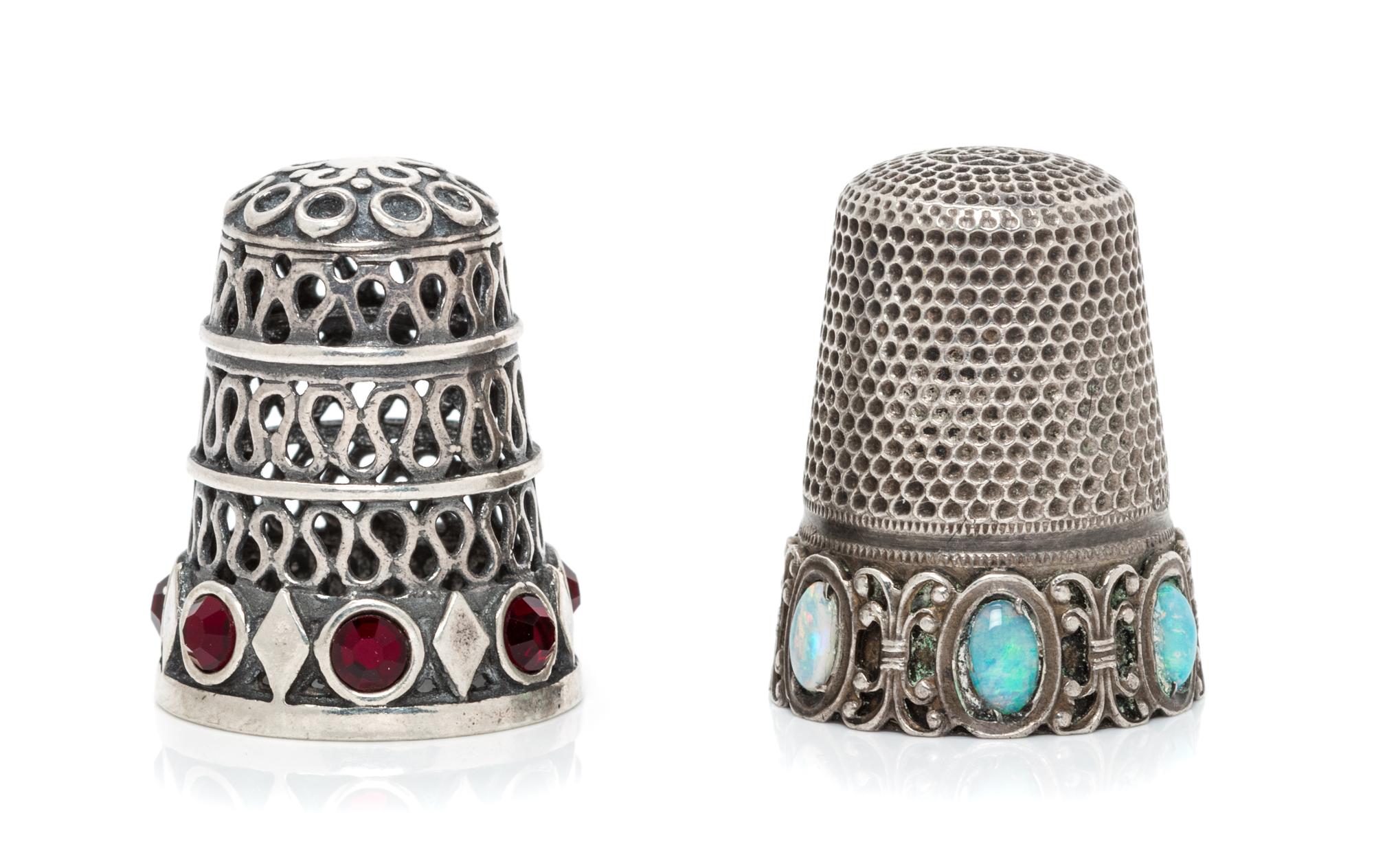 A Group of Two Continental Silver and Stone Thimbles, , comprising an example with three tiers of pierced wrigglework above a band of l