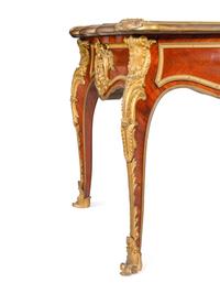 A Louis XV Style Gilt Bronze Mounted and Tooled Leather-Inset Tulipwood Bureau Plat