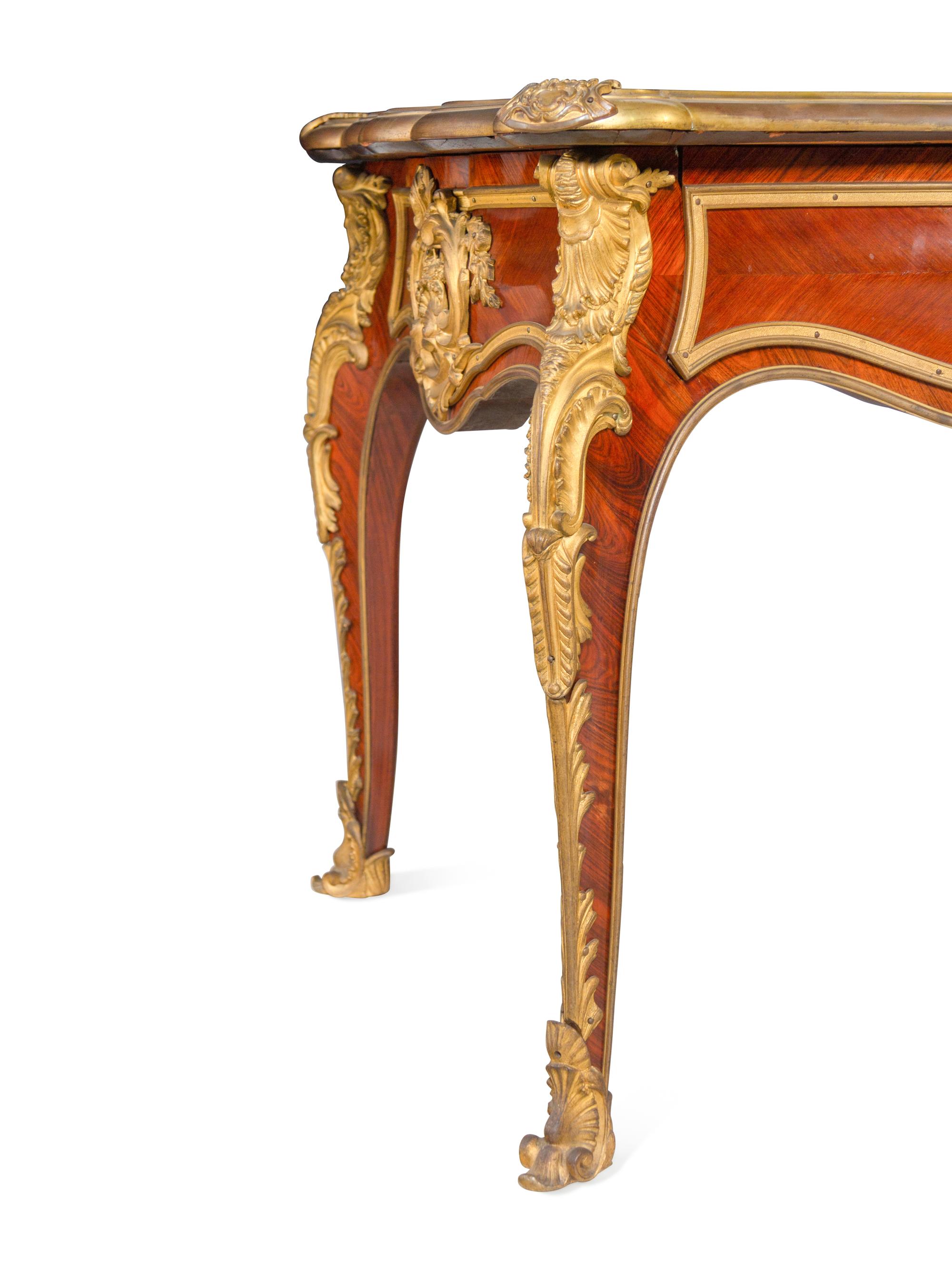 A Louis XV Style Gilt Bronze Mounted and Tooled Leather-Inset Tulipwood Bureau Plat