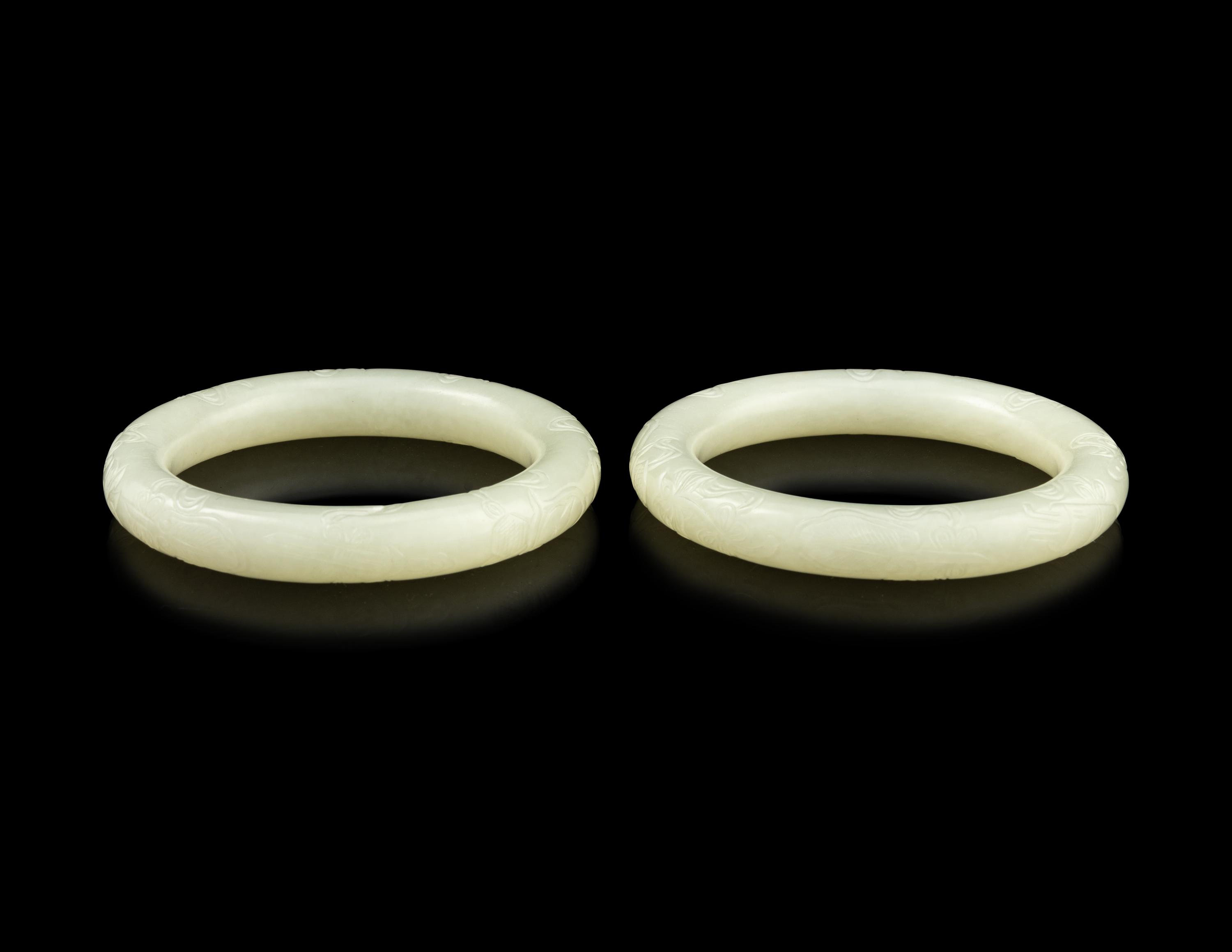 A Pair of Carved White Jade Bangles