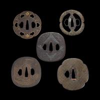 Group of ten Japanese inlaid iron tsuba Edo period or earlier