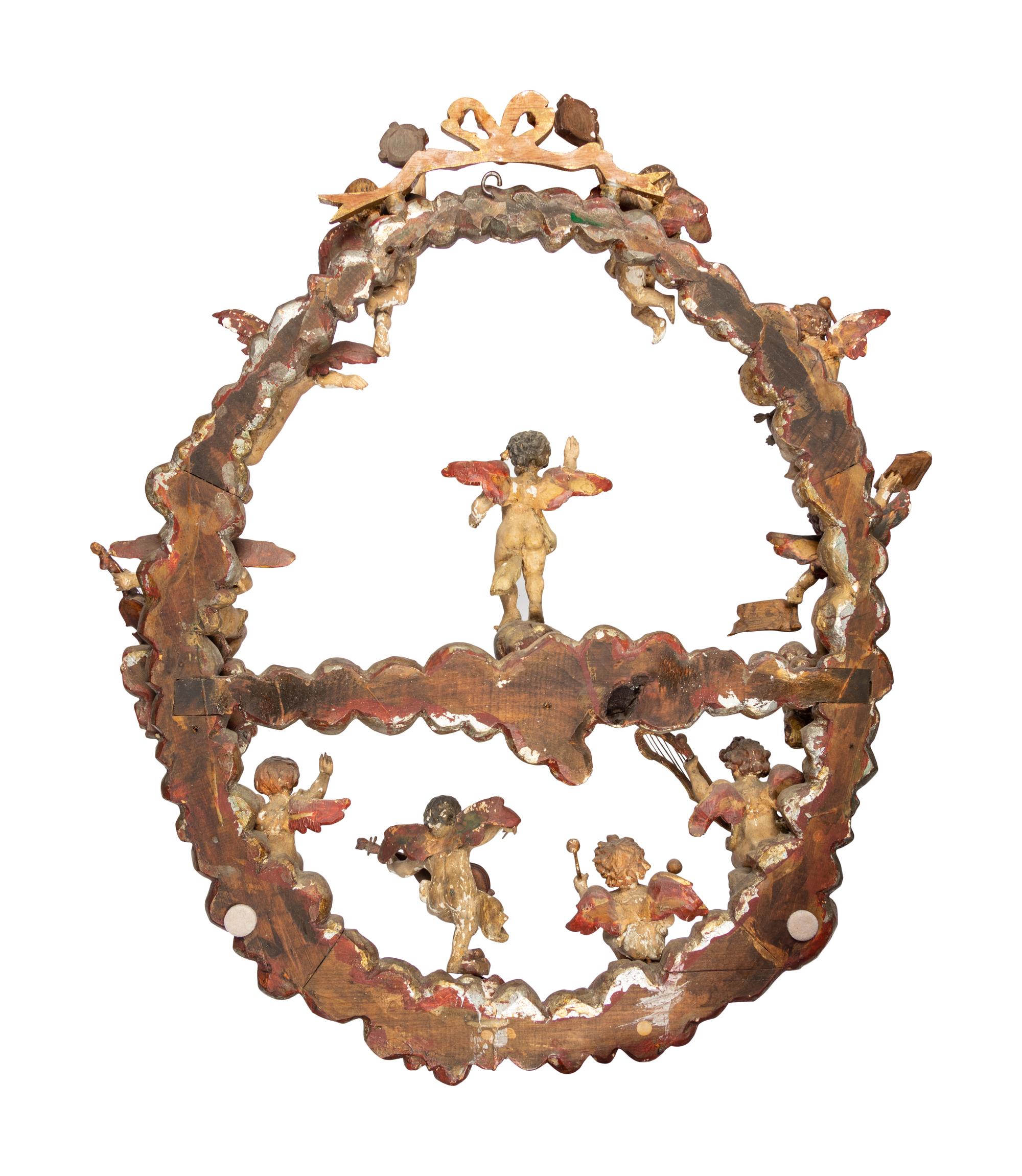 A Florentine Carved Giltwood and Silvered Wood Altarpiece with Musical Putti