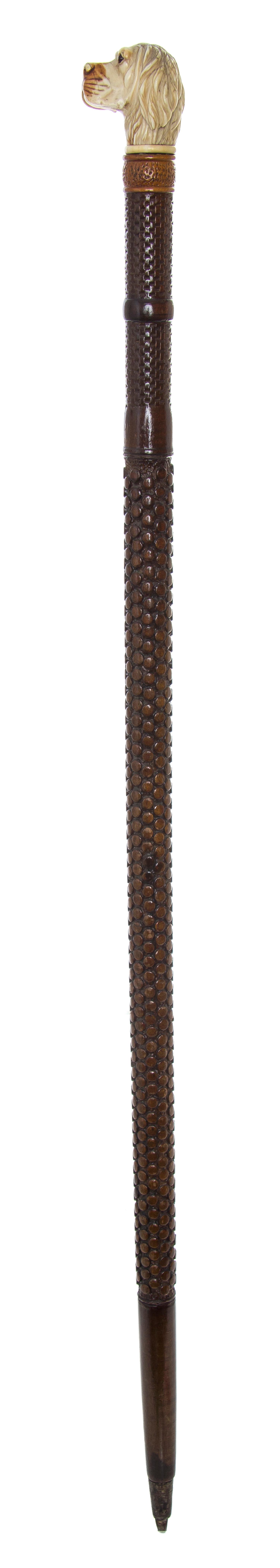 A Carved Wood Cane, Length of handle 2 x length overall 32 inches.