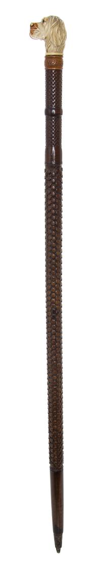 A Carved Wood Cane, Length of handle 2 x length overall 32 inches.