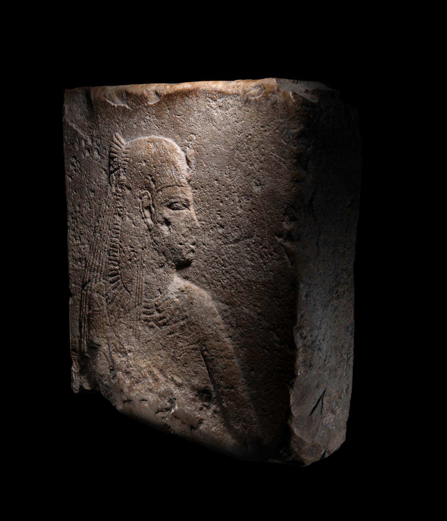 An Egyptian Stone Relief Fragment of a Female Pharaoh or Goddess