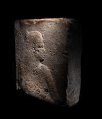 An Egyptian Stone Relief Fragment of a Female Pharaoh or Goddess