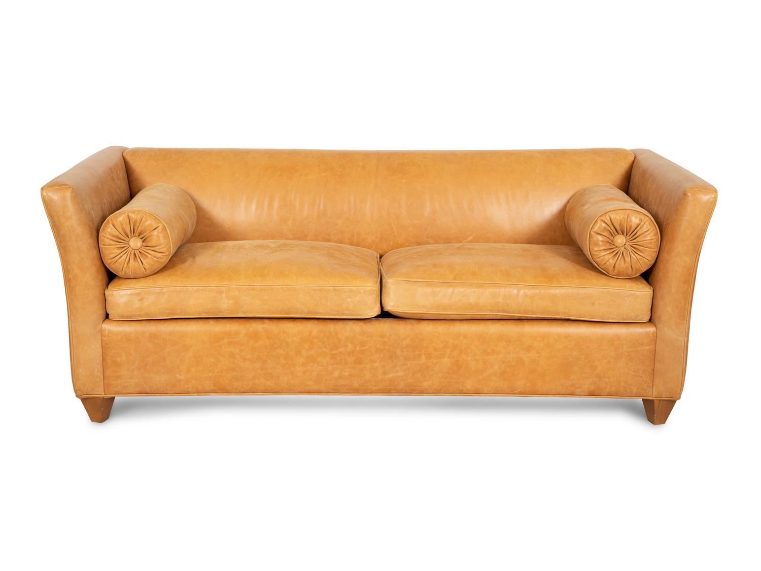A Contemporary Leather Sofa with Two Bolster Pillows