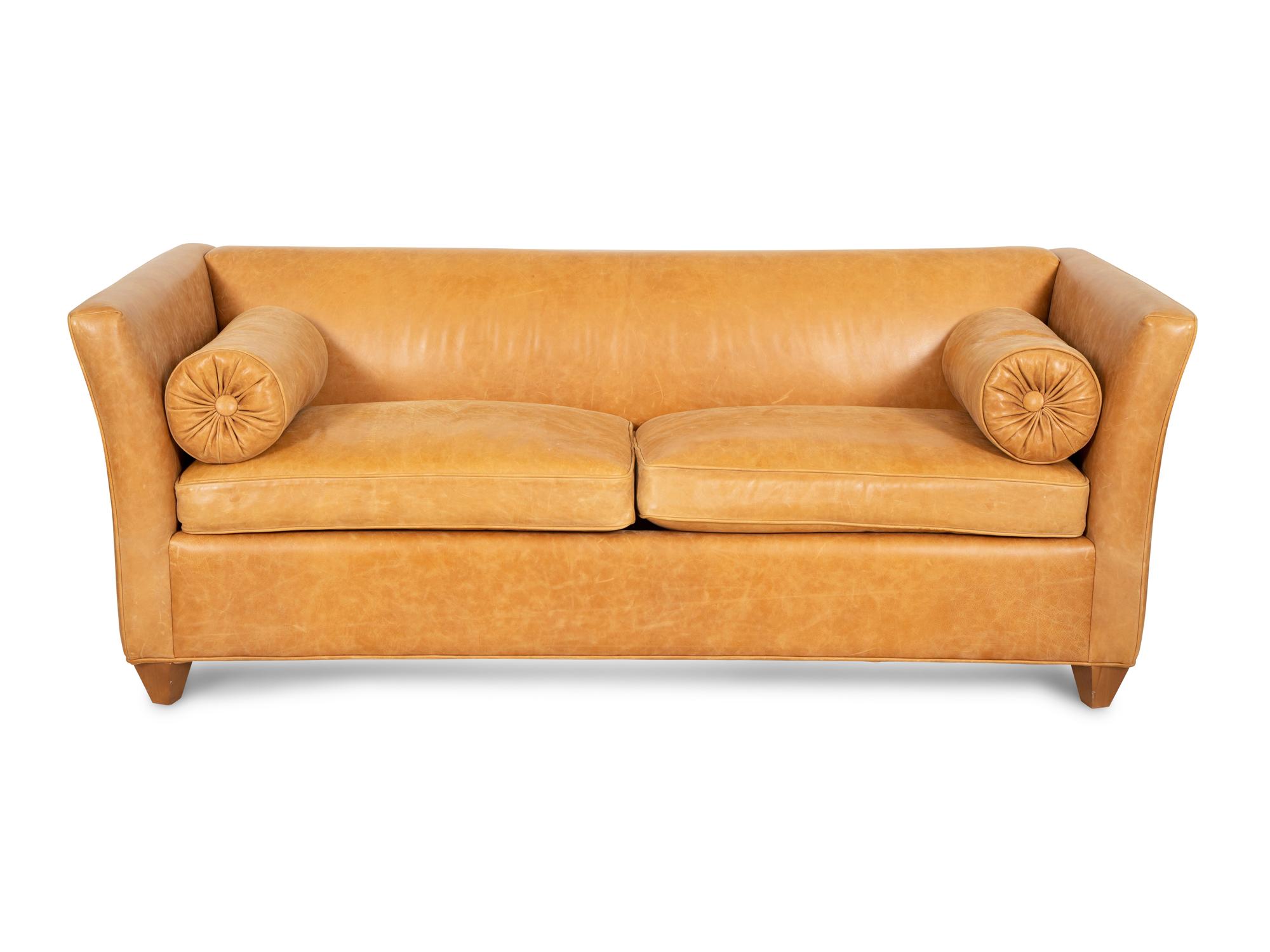 A Contemporary Leather Sofa with Two Bolster Pillows