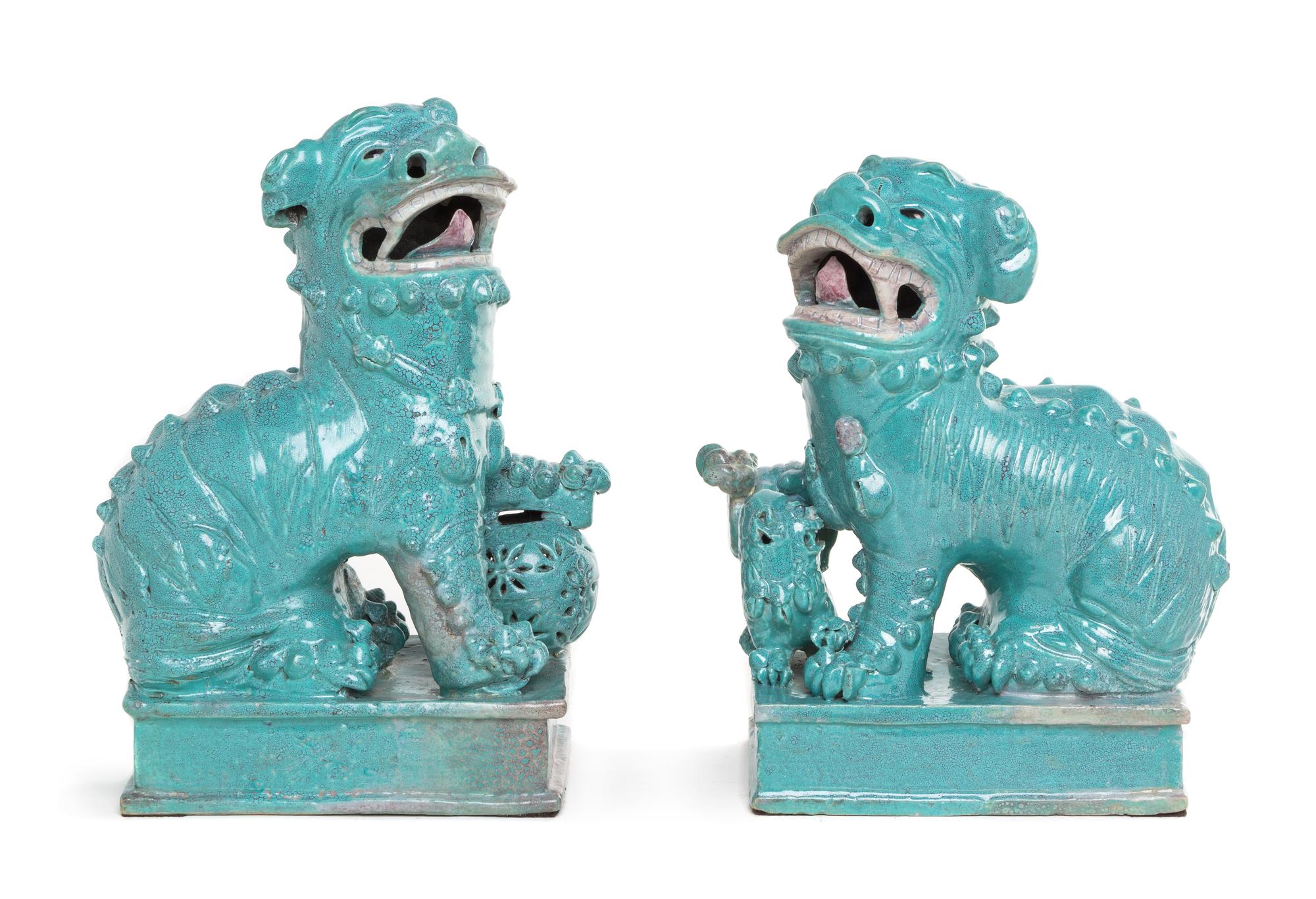 A Pair of Robin's Egg Glazed Porcelain Figures of Fu Lions Height of taller 10 1/4 inches. — 19TH CENTURY