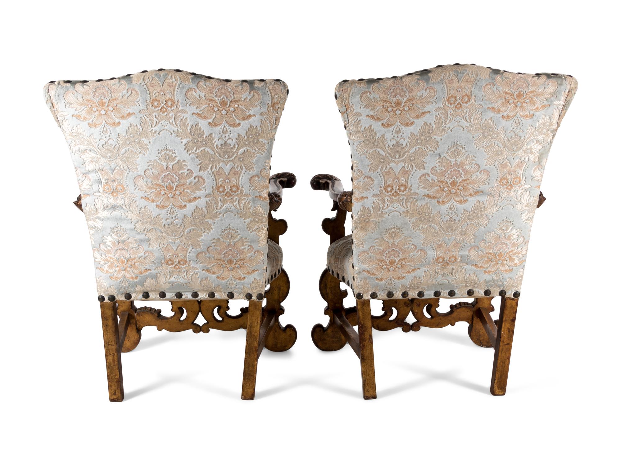 A Pair of Italian Baroque Style Parcel Gilt Walnut Armchairs