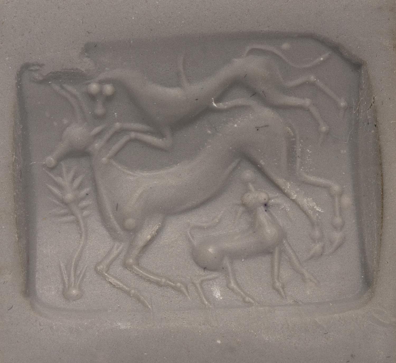 A Minoan Agate Taploid Seal with a Lion Attacking a Cow and Calf