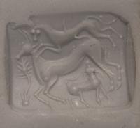 A Minoan Agate Taploid Seal with a Lion Attacking a Cow and Calf