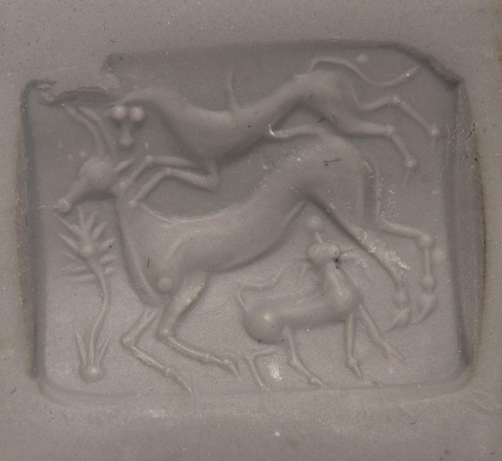 A Minoan Agate Taploid Seal with a Lion Attacking a Cow and Calf