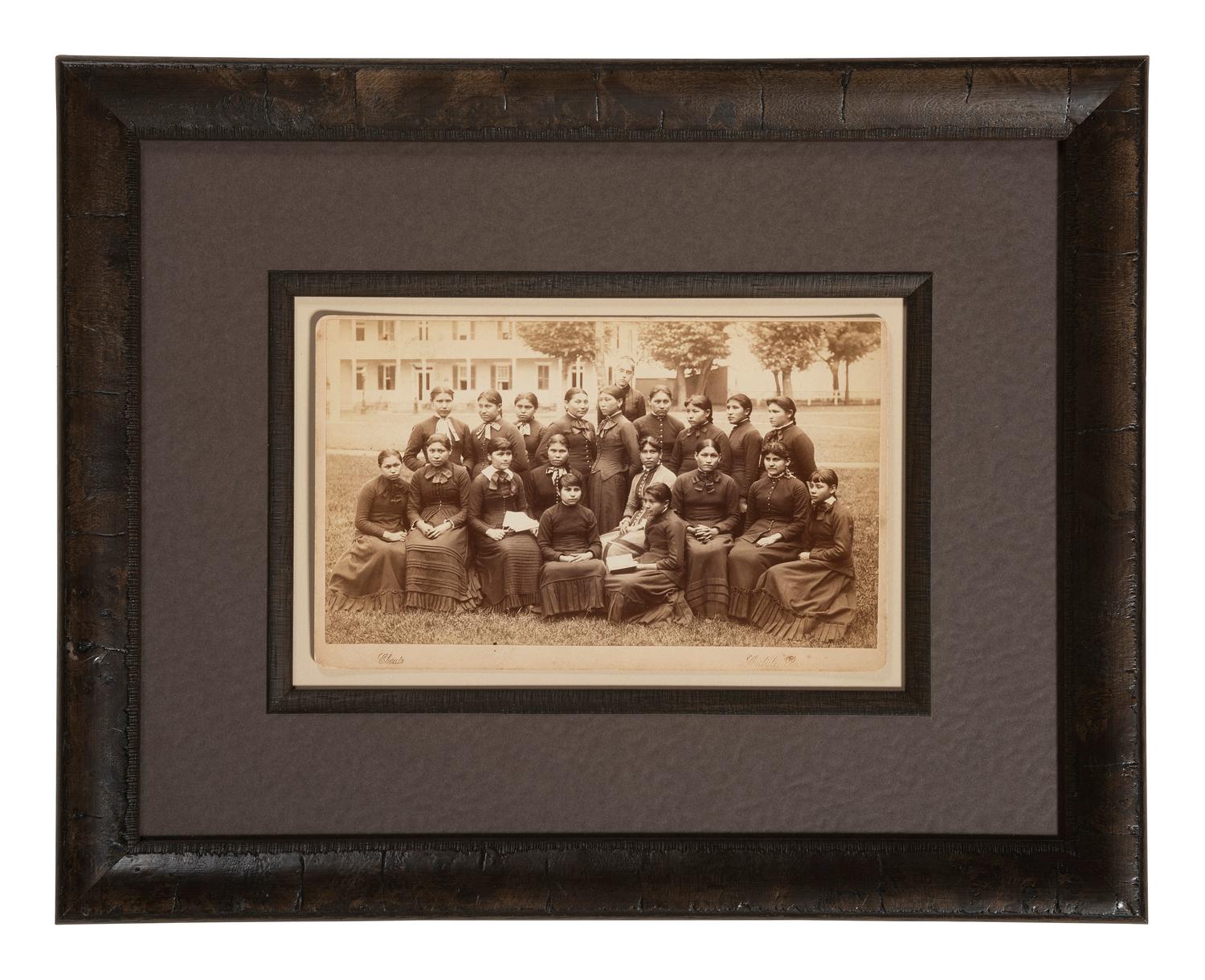 CHOATE, John N. (1848-1902), photographer. Boudoir card of a class of female students with their teacher at Carlisle Indian School. Carlisle, PA, n.d.