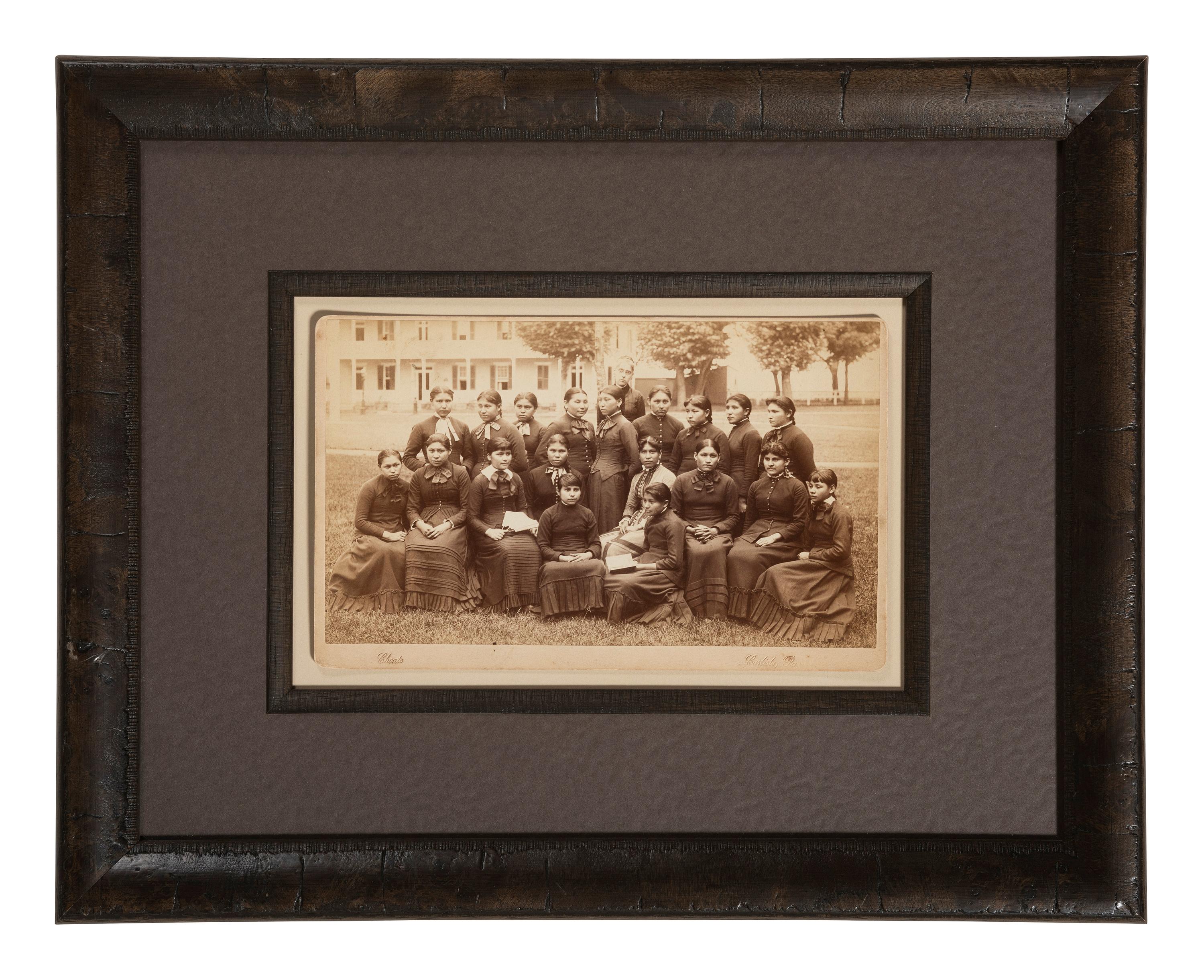 CHOATE, John N. (1848-1902), photographer. Boudoir card of a class of female students with their teacher at Carlisle Indian School. Carlisle, PA, n.d.