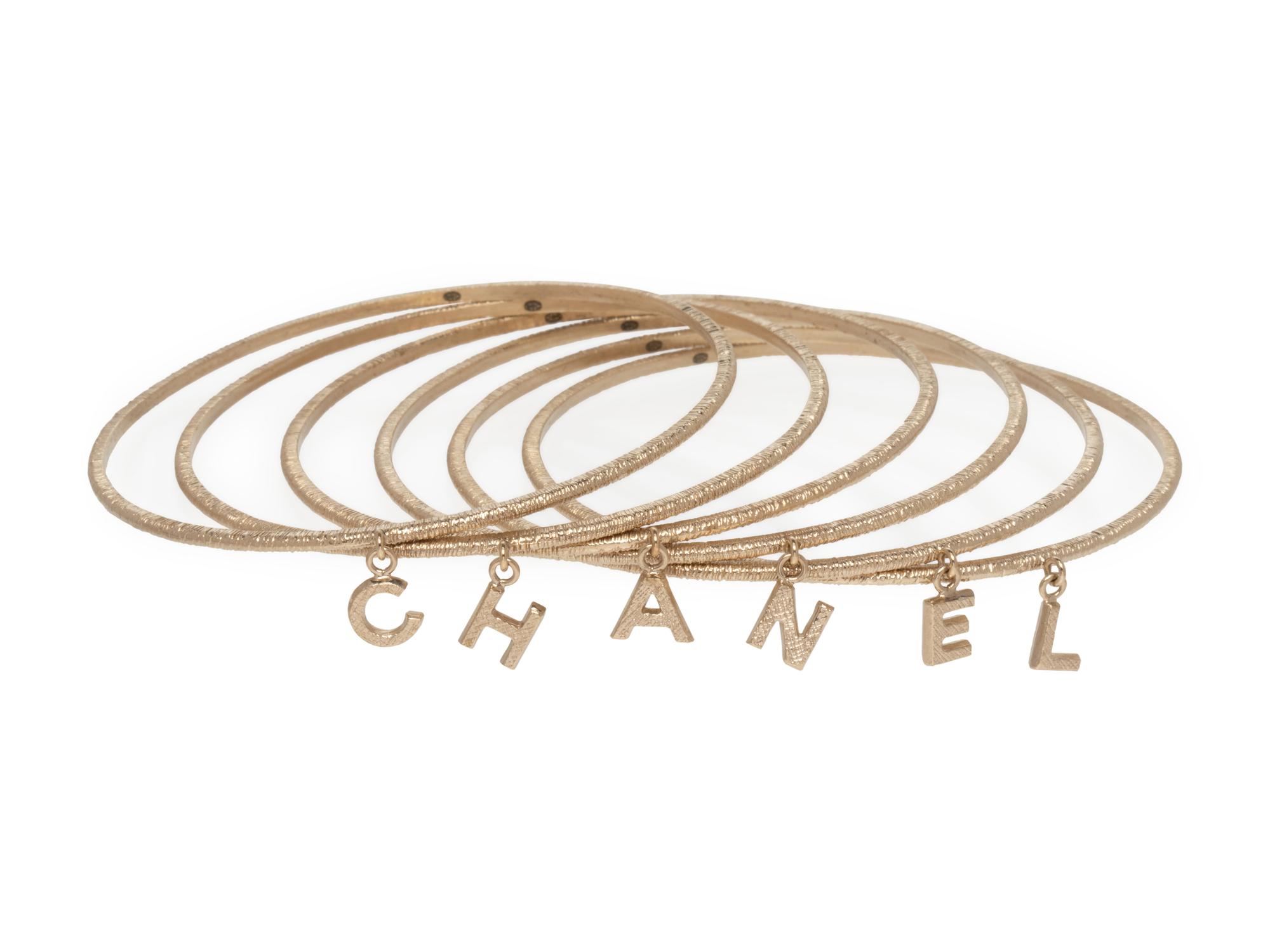 Chanel Set of Goldtone Bangles with "Chanel" Letter Charms, 1997