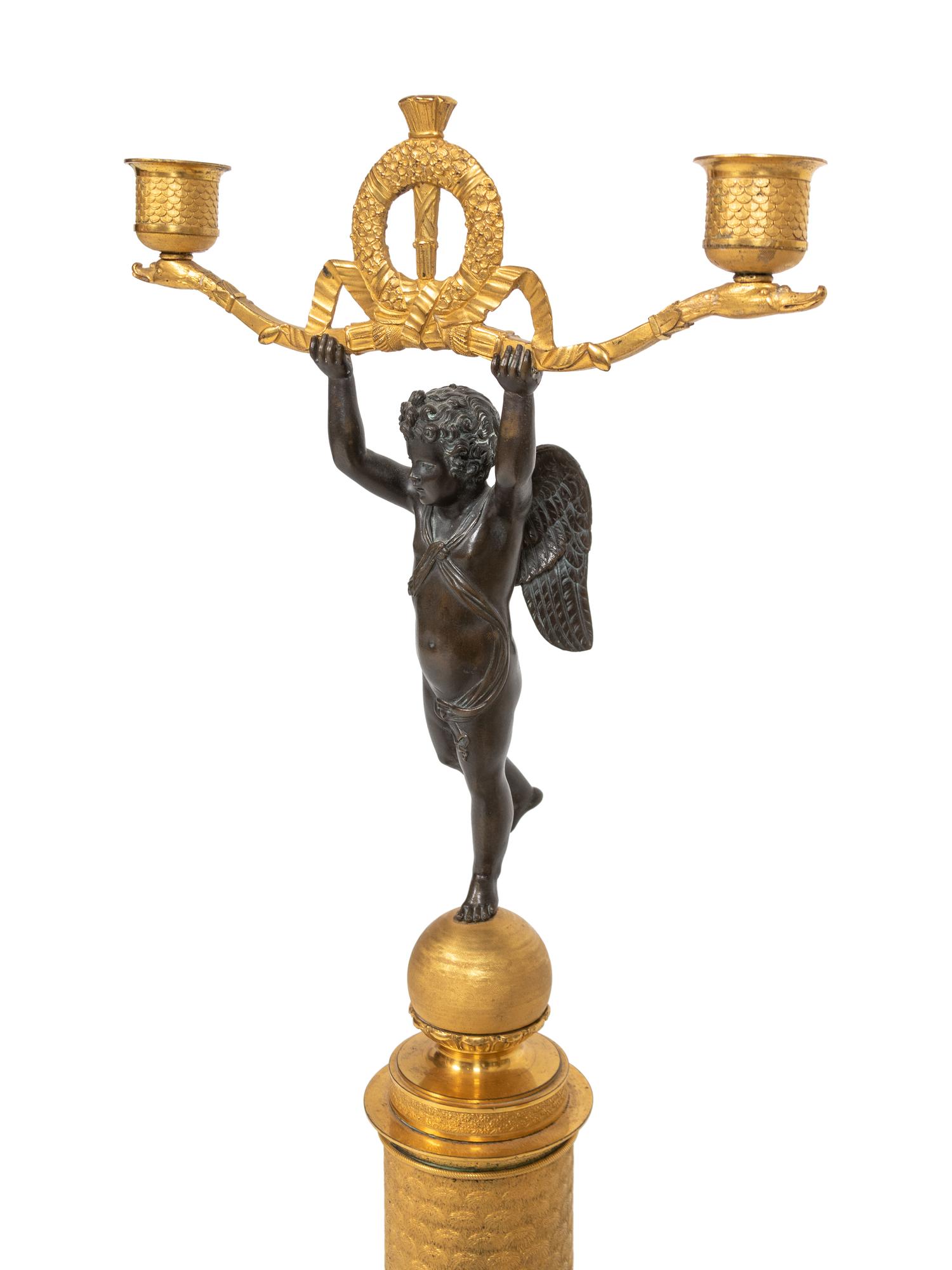 A Pair of Empire Style Parcel-Gilt and Patinated Bronze Figural Two-Light Candelabra