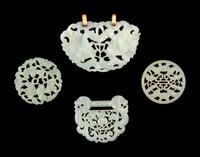 Four Chinese Reticulated Jade and Serpentine Pendants