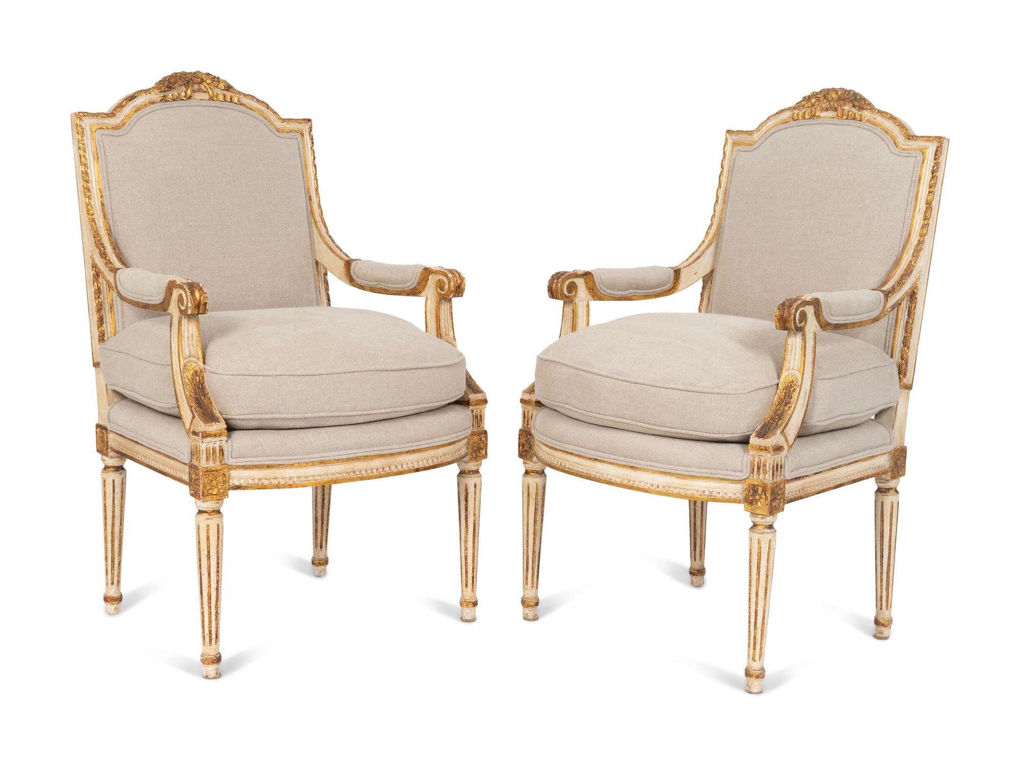 A Pair of Louis XVI Style Painted and Parcel Gilt Fauteuils — EARLY 20TH CENTURY