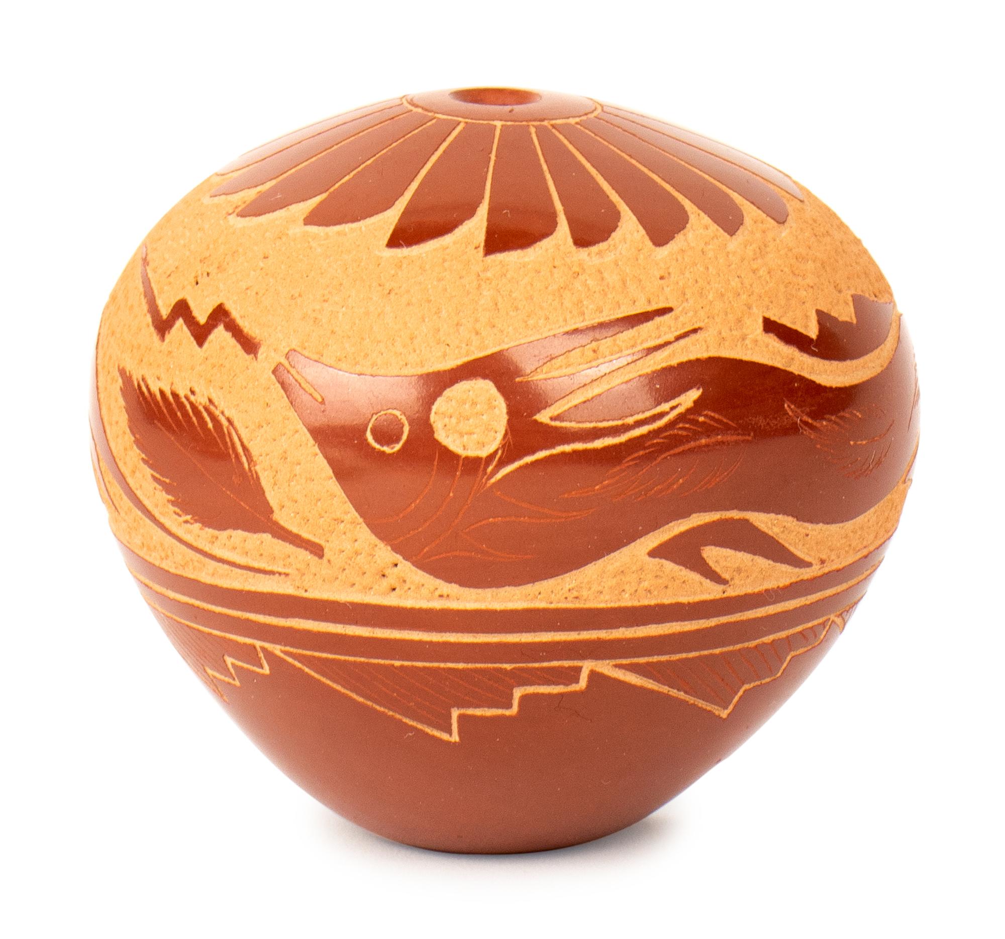 Red Seed Jar, with shallow carvings resembling birds