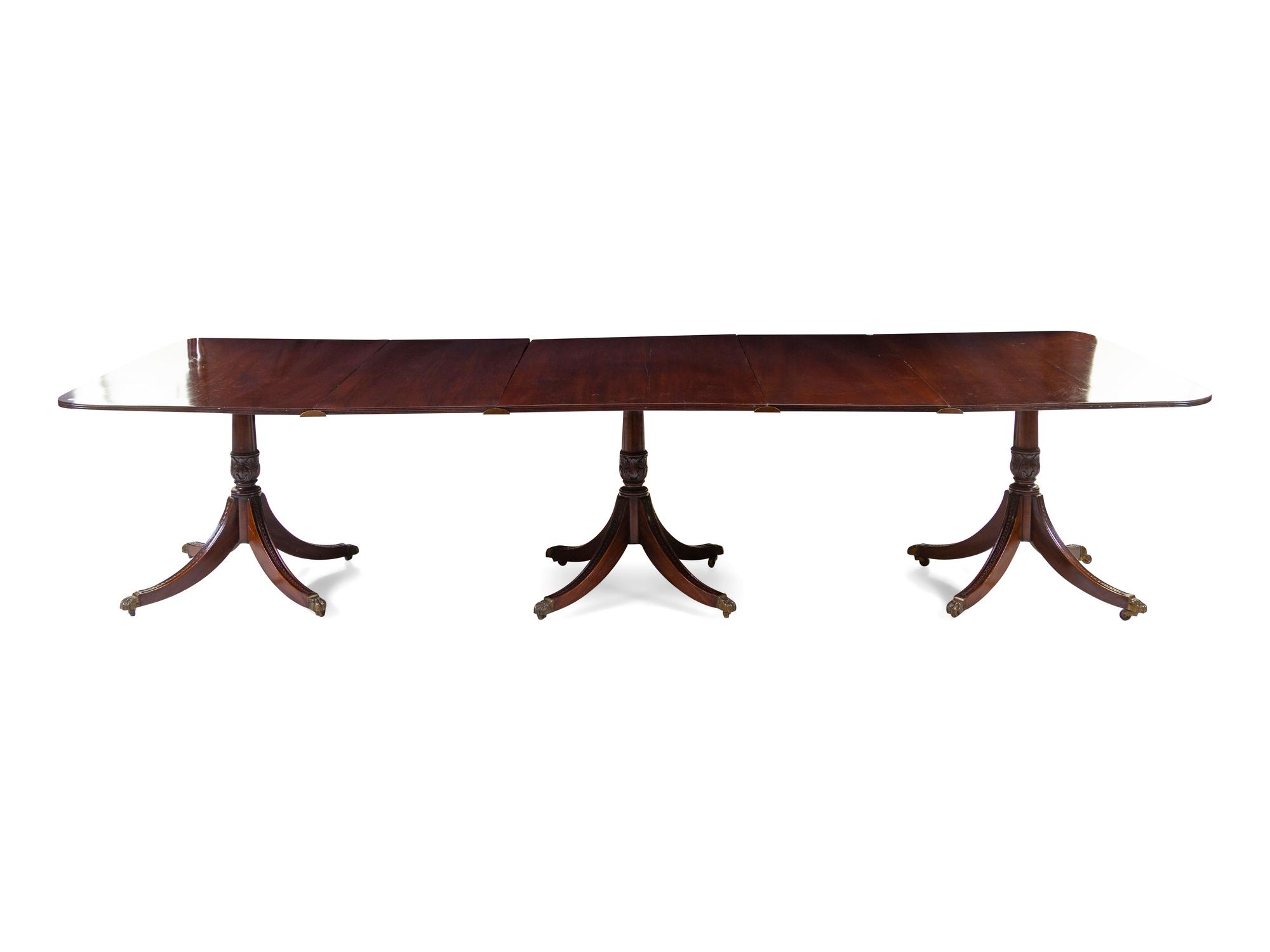 A Regency Style Mahogany Triple-Pedestal Extension Dining Table