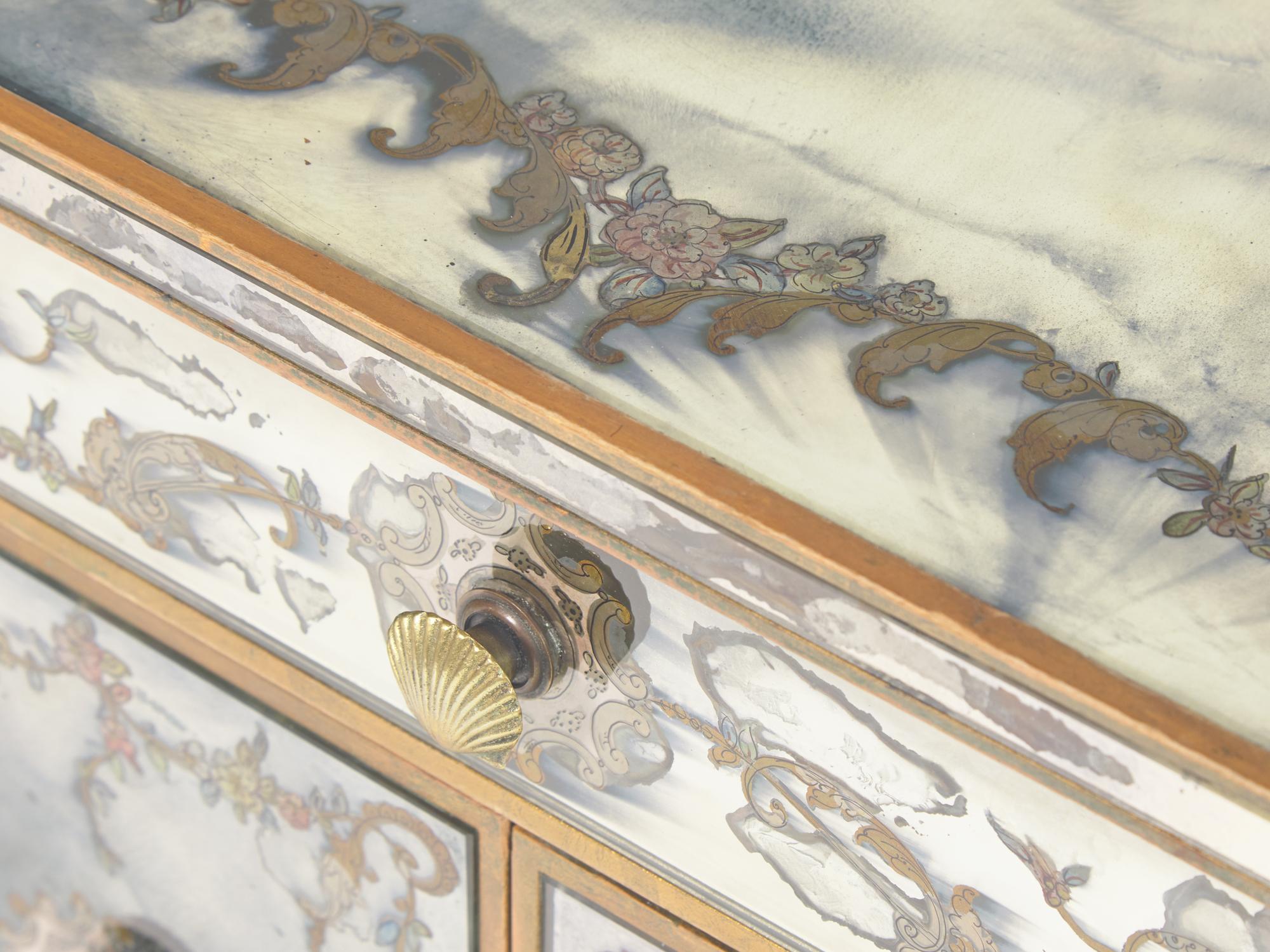 A Pair of Venetian Style Reverse-Painted Glass and Mirrored Petite Commodes