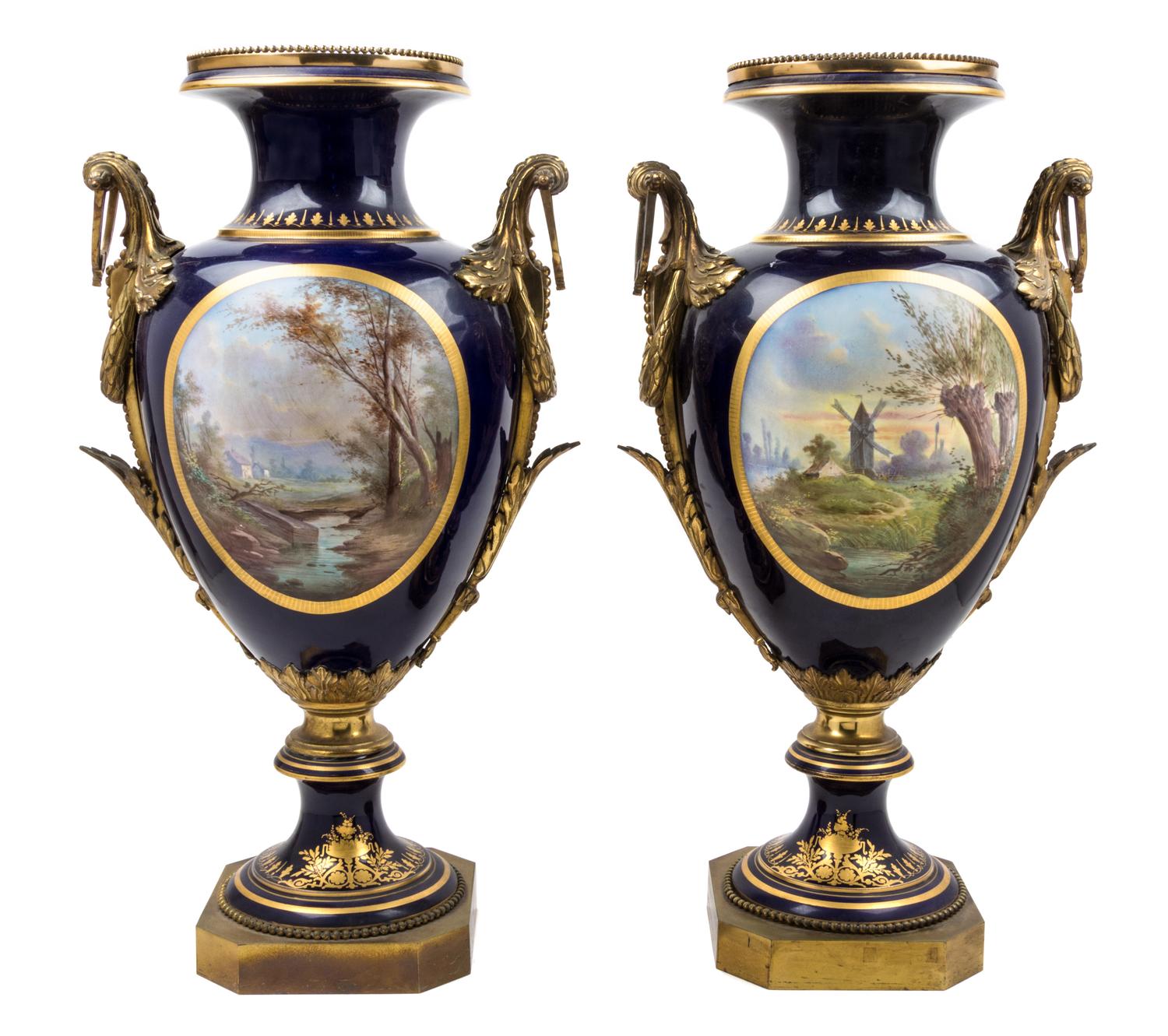 A Pair of Sevres Gilt Bronze Mounted Porcelain Urns Height 30 inches.