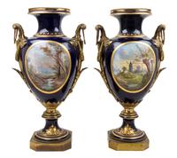 A Pair of Sevres Gilt Bronze Mounted Porcelain Urns Height 30 inches.
