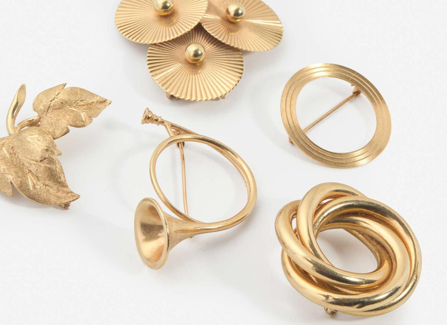 A Collection of Yellow Gold Brooches