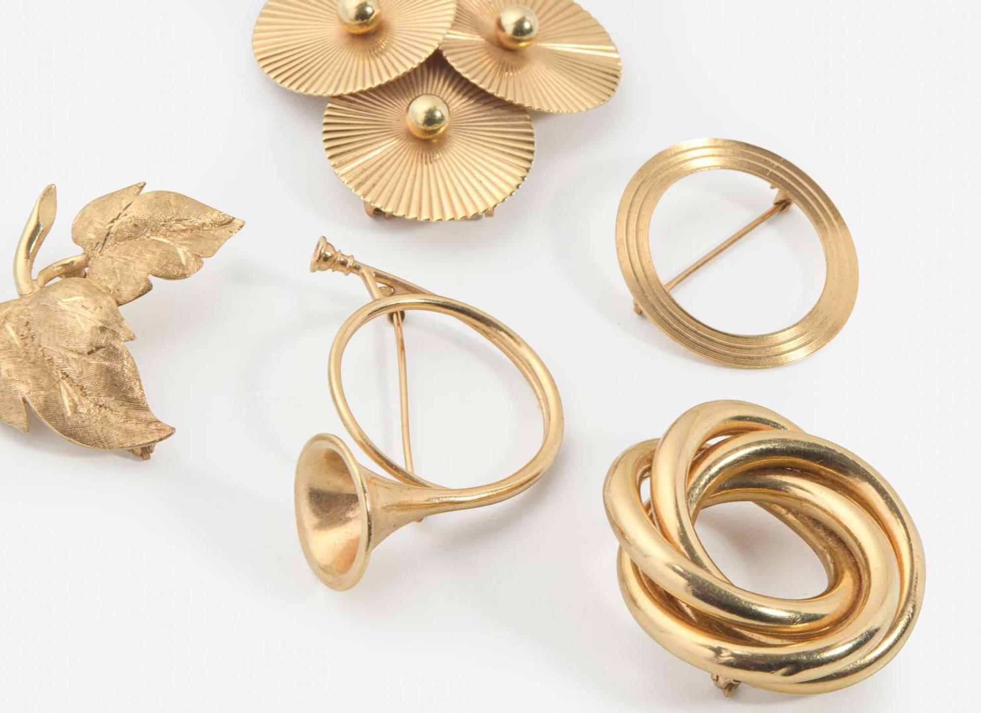 A Collection of Yellow Gold Brooches