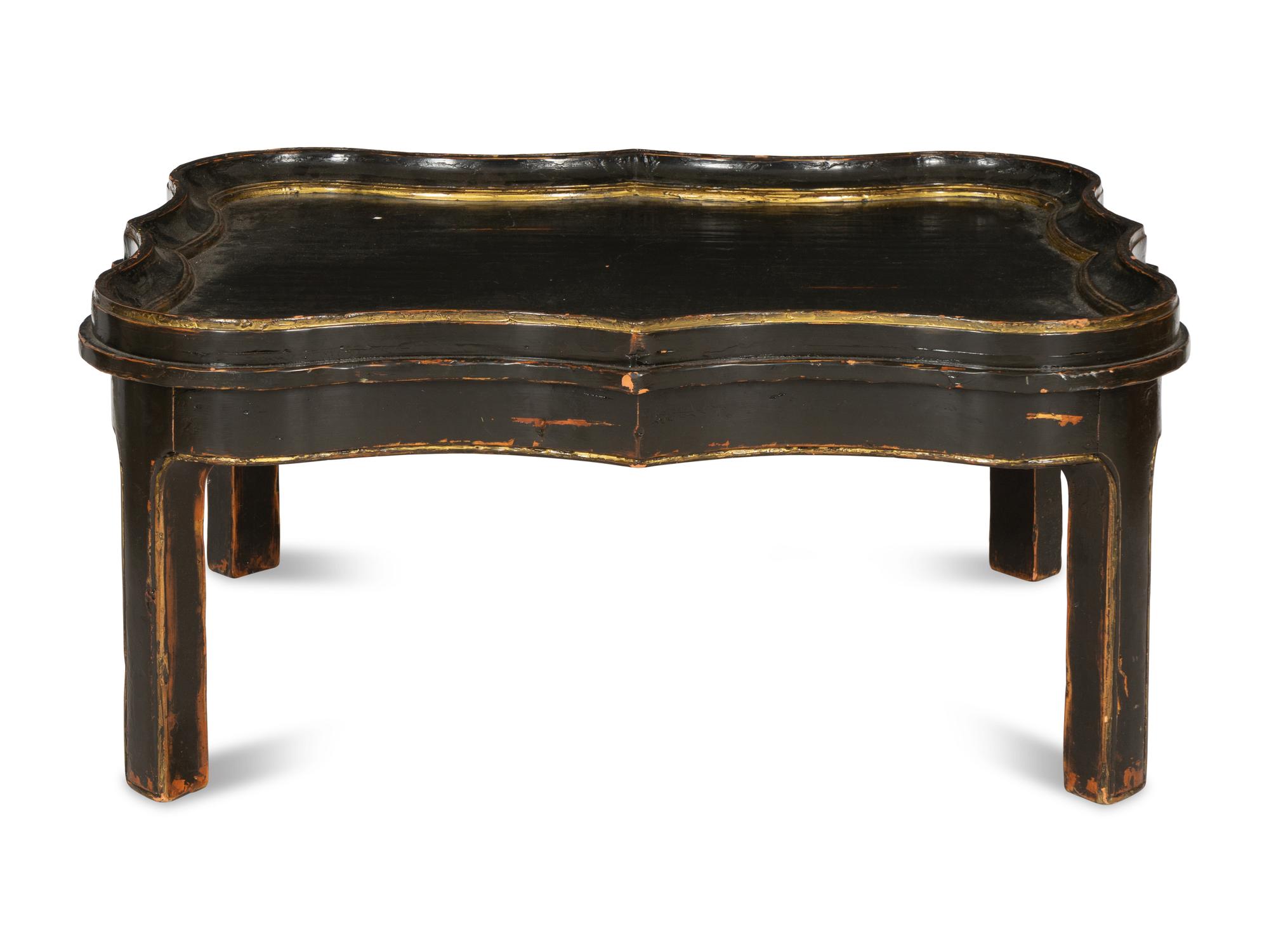 A Cartouche-Form Ebonized and Parcel Gilt Low Table