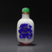 A Chinese Glass Overlay "Dragon and Phoenix" Snuff Bottle, Qing Dynasty, 18th Century — 清中期 涅白地套雙色料龍鳳紋鼻煙壺