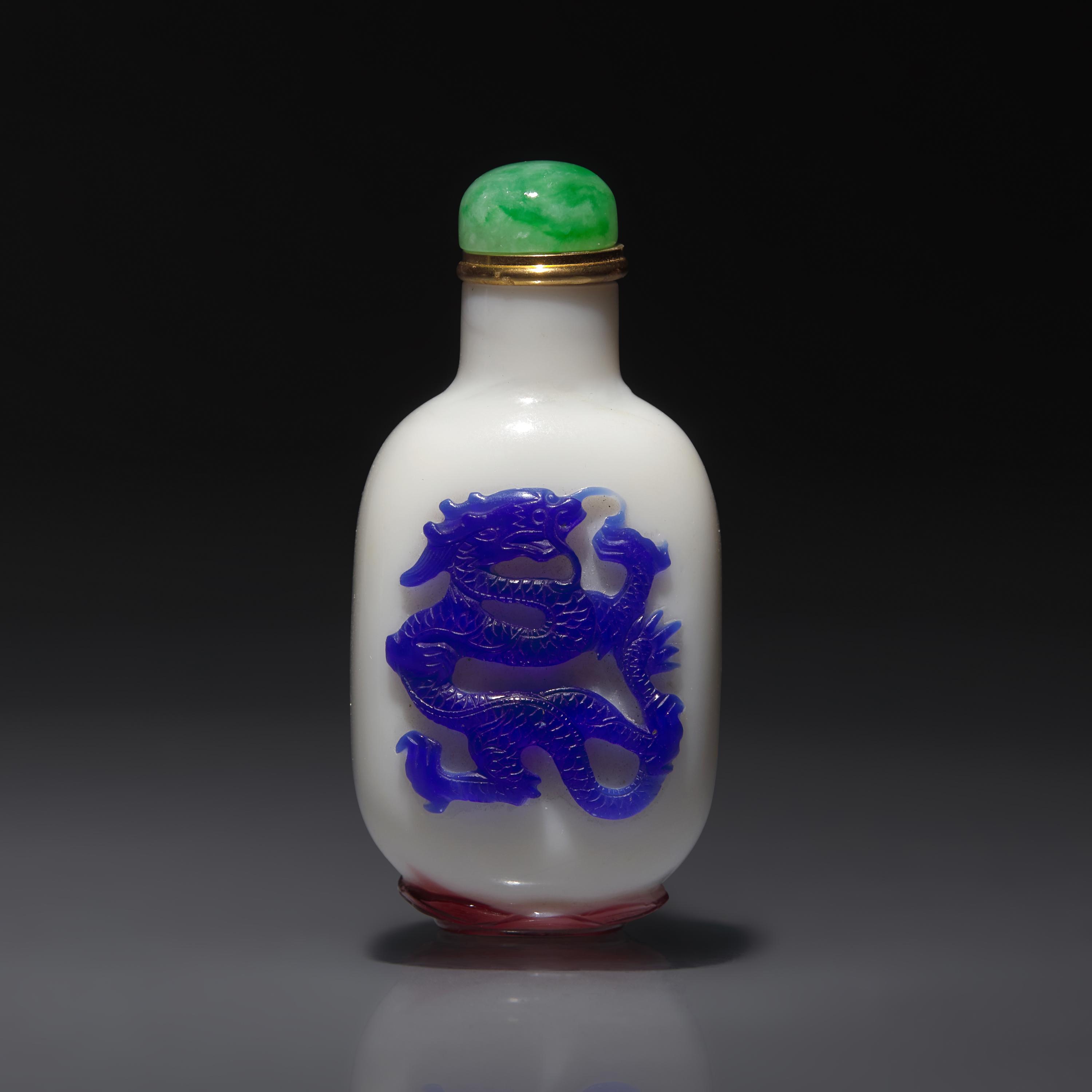 A Chinese Glass Overlay "Dragon and Phoenix" Snuff Bottle, Qing Dynasty, 18th Century — 清中期 涅白地套雙色料龍鳳紋鼻煙壺