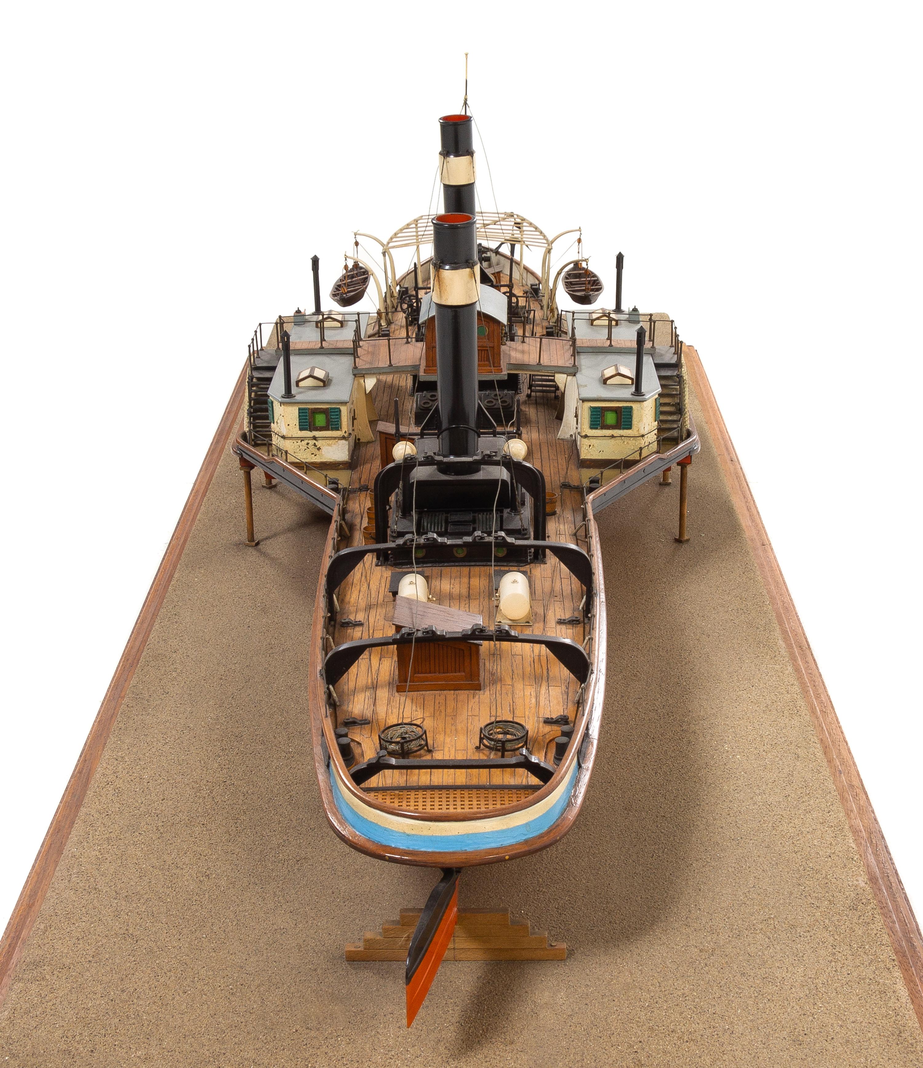 A Model of the Side Wheel Tug Munchen Height of model 14 x length of base 58 5/8 inches.