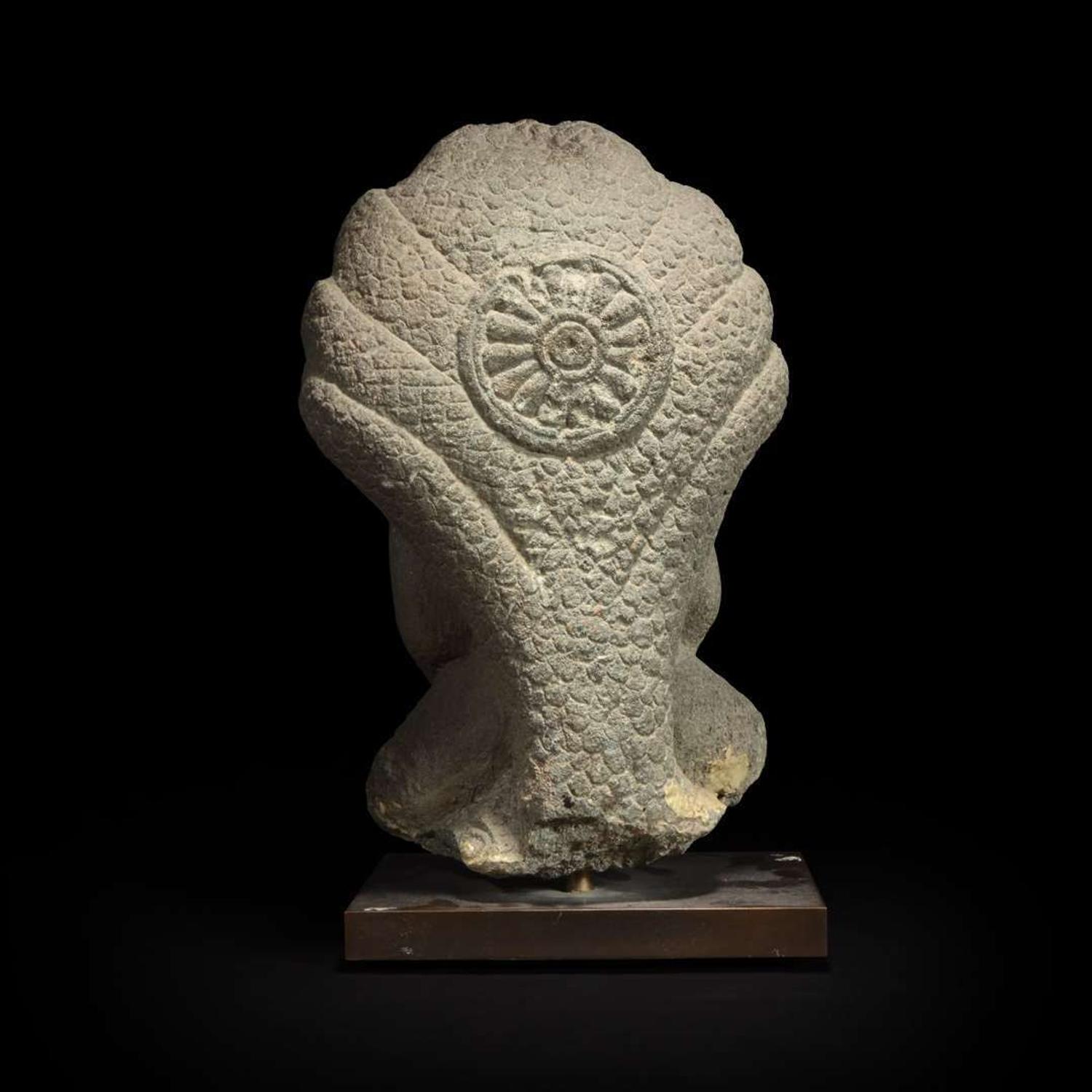 A Khmer style carved stone figure of Buddha seated under a cobra canopy 高棉风格石雕眼镜蛇冠冕佛首
